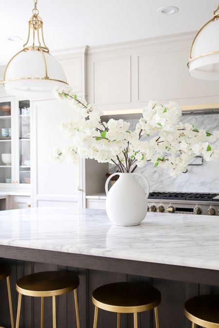 Kitchen, home decor, interior design, neutral, warm, cozy, cooking, baking, family home, jug, vase, faux flowers, white and gold pendant lights, white marble, hutch, china cabinet, gold bar stools, kitchen island 

#LTKhome #LTKstyletip #LTKSeasonal