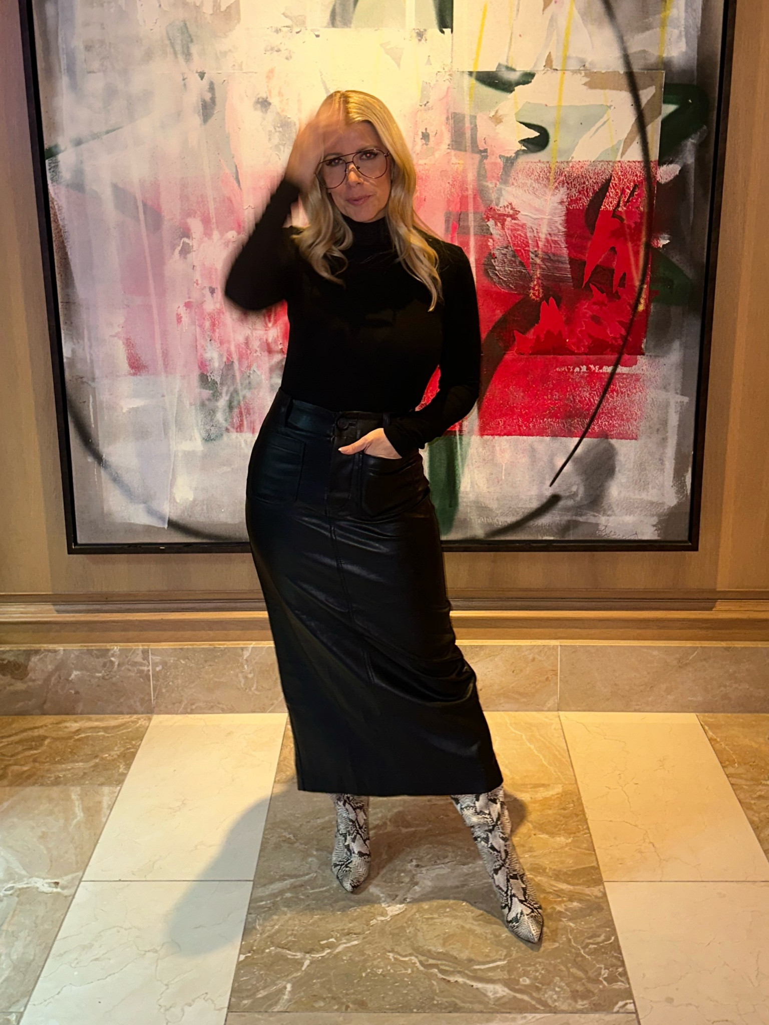 And the skirt I’m wearing a size XS. And the turtleneck I’m wearing a size medium. And the shoes run true to size.