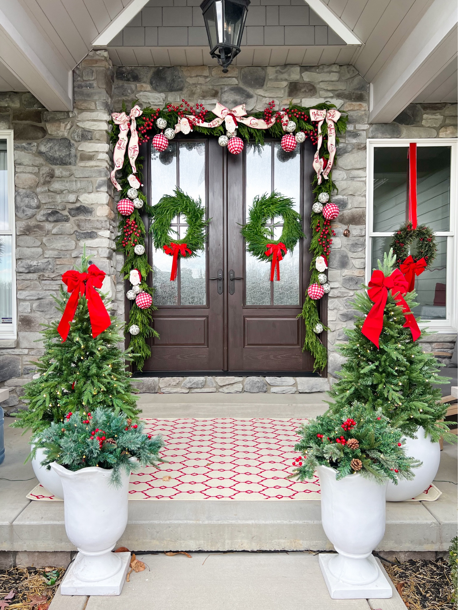 Linking just about everything I used for my holiday front porch! 
Promo code BEYOND_GRAY can be used for the deluxe Norfolk garland that I used around the doorway (code is only good if you purchase through AFloral). Promo code BEYOND can be used for the wreaths and anything else at The Accidental Farmgirl. I purchased the Santa Believe ribbon at Decorators Warehouse but they are not linkable on LTK so I’m linking through a different retailer. These porch trees are prelit and so nice!!! I ended up ordering two more for the back porch. The container filler is also prelit (battery operated) and has been a best seller! Also linking the tension bracket that I used to hang the garland above the doors without having to use nails or screws. It comes in multiple adjustable sizes (double or single) and finishes. 

#LTKHome #LTKHoliday #LTKSeasonal