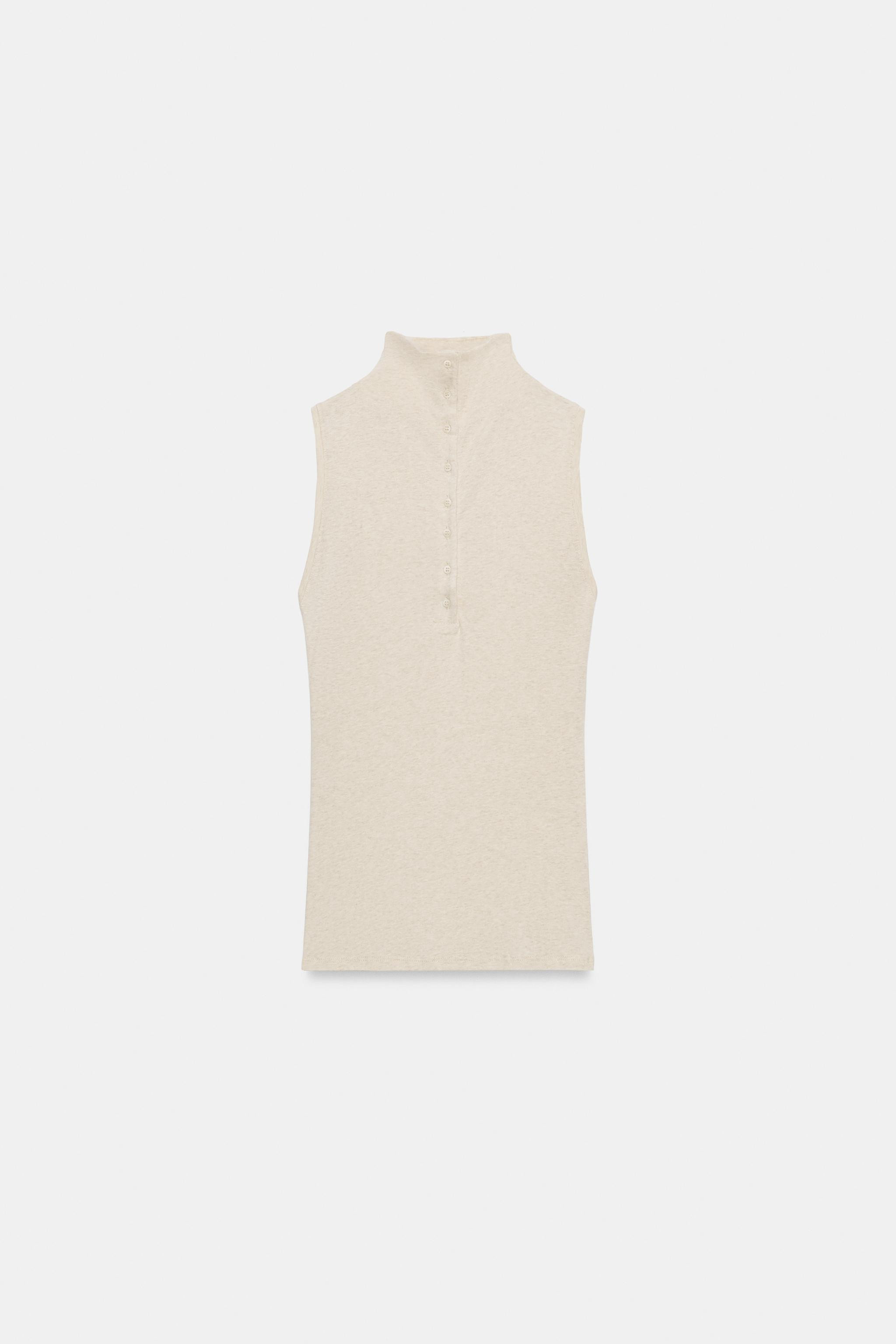 Top crafted from cotton yarn. Featuring a high neck, sleeveless design, straight hem and front bu... | Zara UK