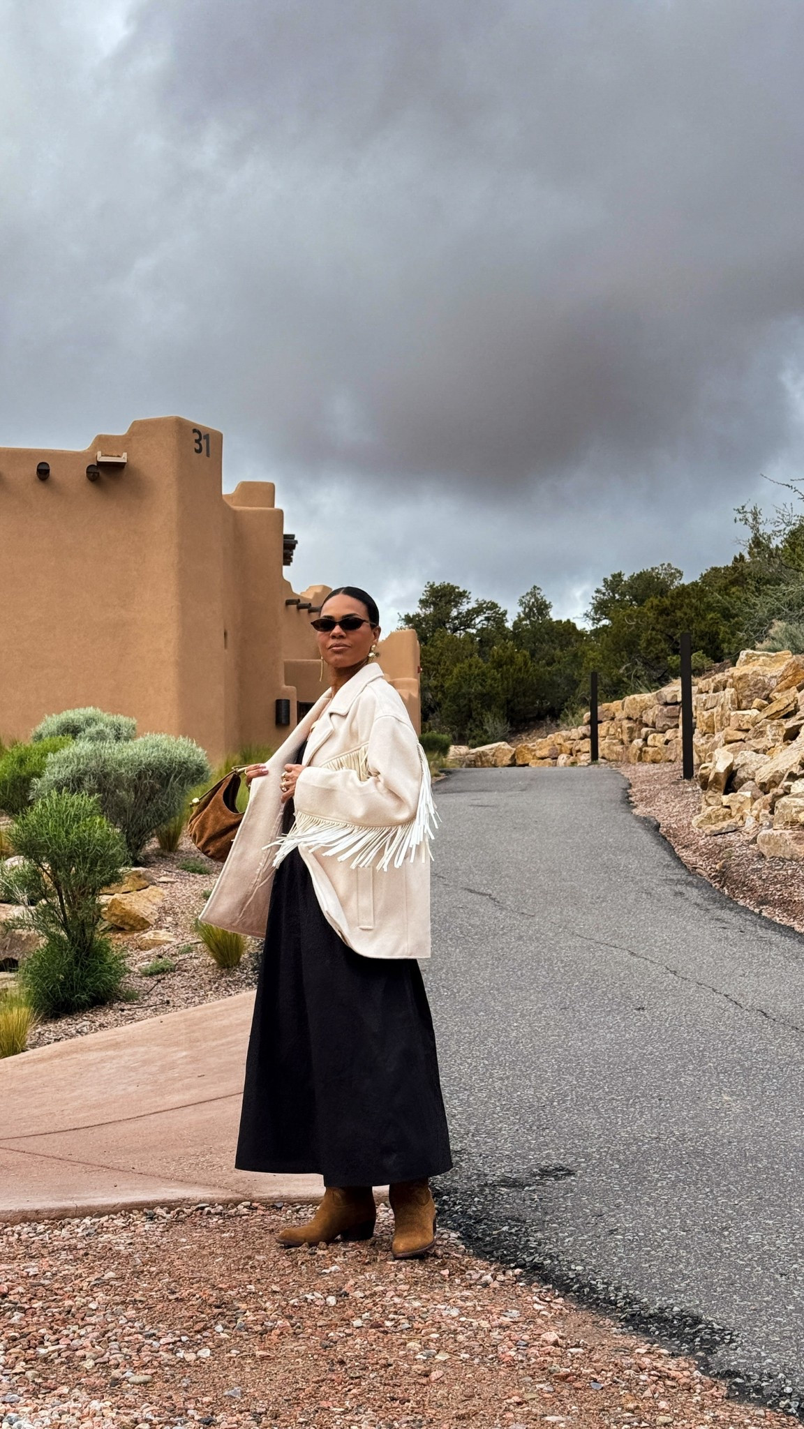 Black dress w/ oversized fringe rodeo jacket, gold & brown handbag, suede boots, gold pendant necklace & sunglasses. 


#LTKOver40 #LTKStyleTip