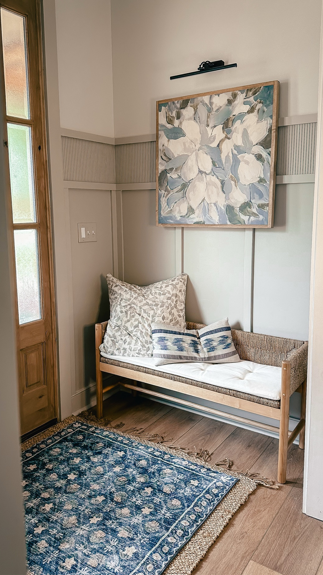 Would you believe that it took just some simple trim work to elevate this entryway? 

Add to this some functional but pretty furnishings, pretty art, and a rug and - voila! A welcoming and charming entryway!

Comment WELCOME below if you want a source list!
