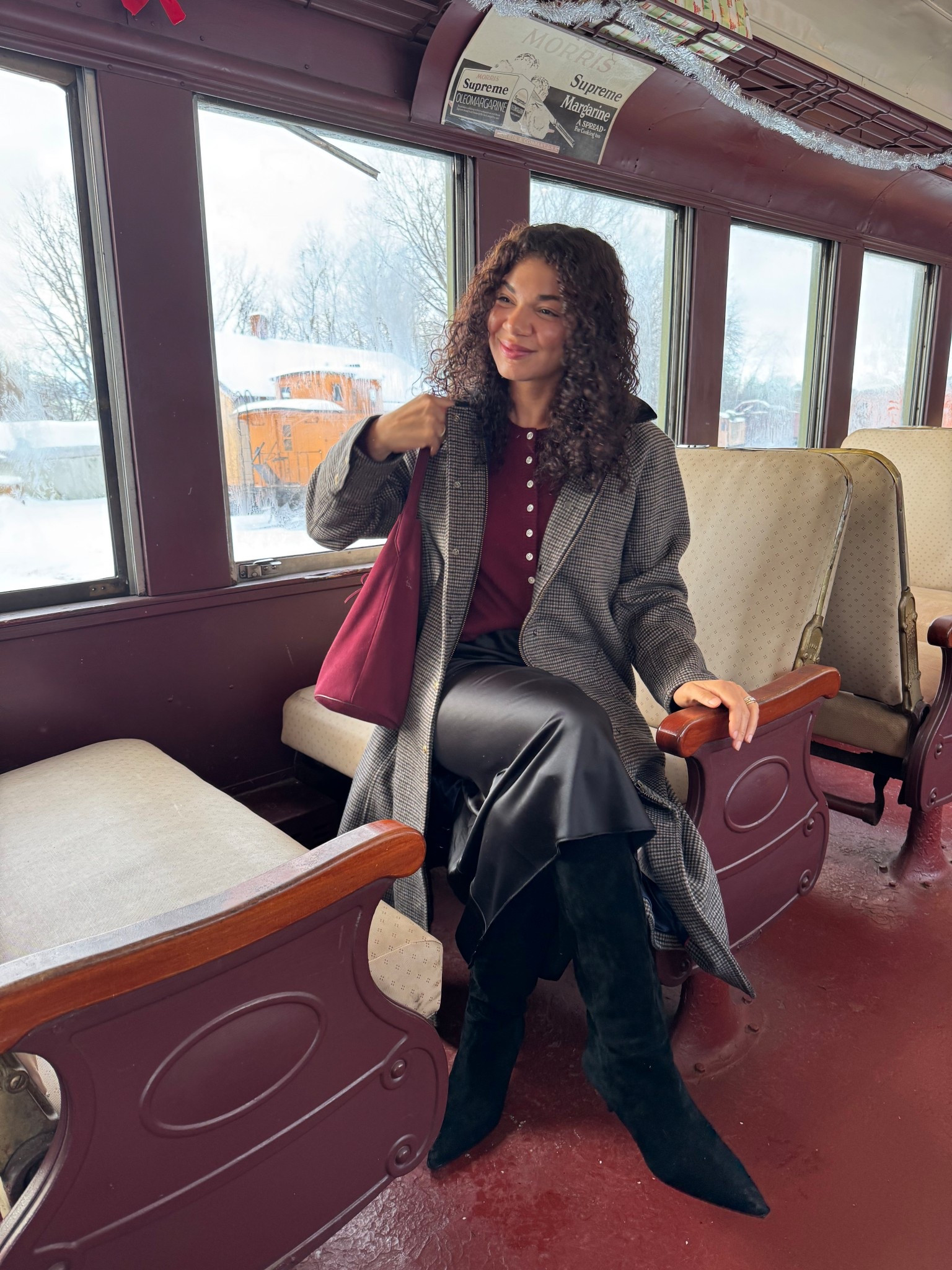 Black slip skirt outfit: slip skirt, knee high boots, cardigan worn as a top, long barn coat, bucket tote bag 

#LTKootd #LTKHoliday