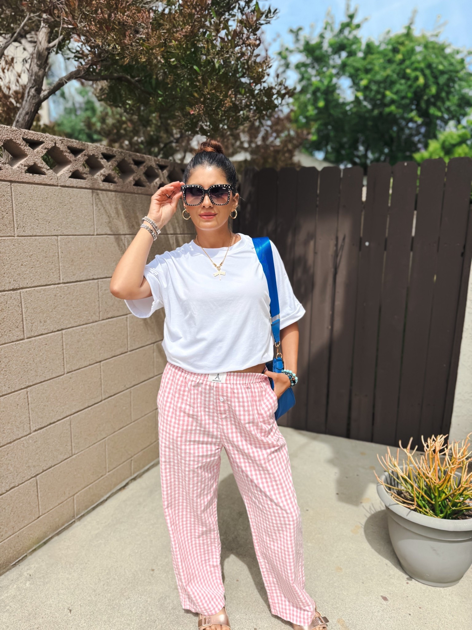 Easy everyday outfit but make it chic 🤍✨
I styled this oversized tee tucked under my bra for that effortless, cinched look (trust me… game changer 🙌). Paired it with these lightweight gingham pants for the perfect casual + put-together vibe.

This is my go-to for running errands, coffee runs, or just feeling cute and comfy without trying too hard. Add a statement sunglass + pop of color bag and you’re instantly elevated 💙

Everything is easy to mix, match, and rewear all season long!


casual outfit, everyday style, oversized tee outfit, t shirt styling hack, tucked shirt trick, gingham pants outfit, spring outfit ideas, summer casual look, mom style outfit, effortless chic outfit, comfy outfit ideas, relaxed fit outfit, neutral outfit with pop of color, street style casual, minimal chic outfit, airport outfit idea, coffee run outfit, laid back fashion, simple outfit inspo

#casualstyle #everydayoutfit #ootdstyle #springoutfits #summerstyle #effortlessstyle #momstyle #comfychic #outfitinspo #ltkstyle #ltkfashion #amazonstyle #ginghamstyle #neutralstyle #streetstyle

#LTKmomlife #LTKootd #LTKSeasonal