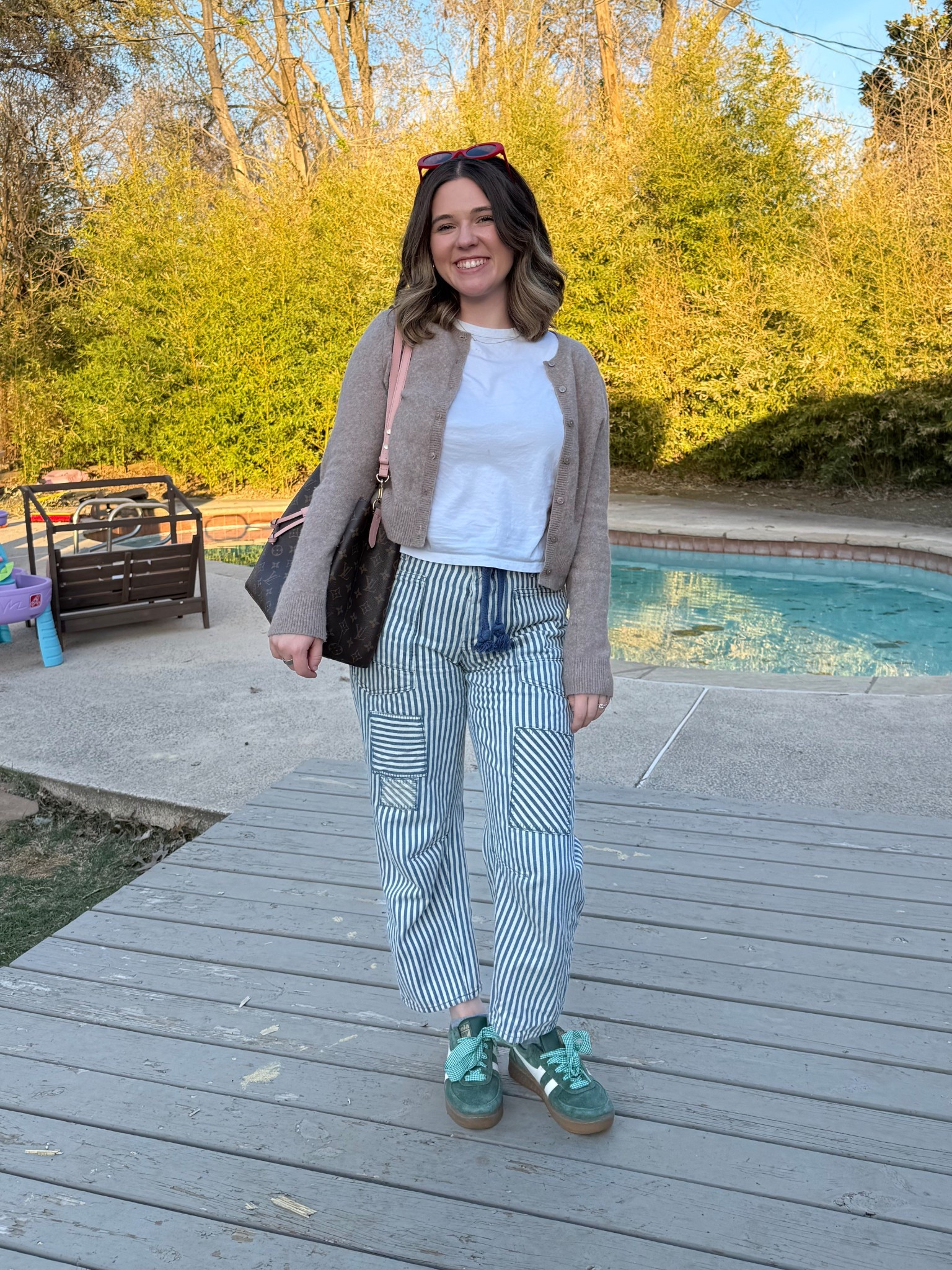 Daily outfit 
Abercrombie cardigan (old but linked similar)
Abercrombie basic white tee
Free people moxie railroad striped pants (LOVE THESE!!)
Gola green sneakers from Buckle
Anthropologie laces 
Madewell red sunglasses 
Louis Vuitton purse 

#LTKStyleTip #LTKItBag #LTKShoeCrush