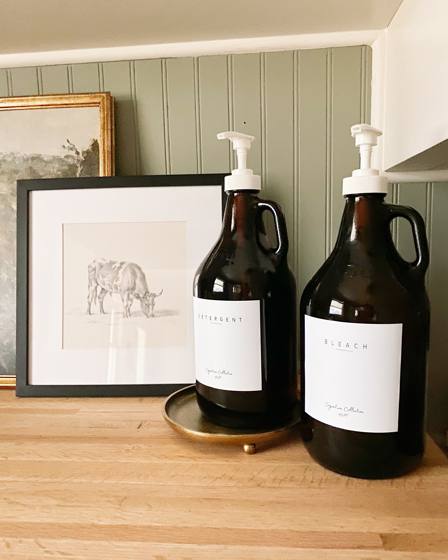 Laundry room countertop decor with glass dispensers and artwork 🧺 #laundry #laundryroom #decor

#LTKhome #LTKstyletip