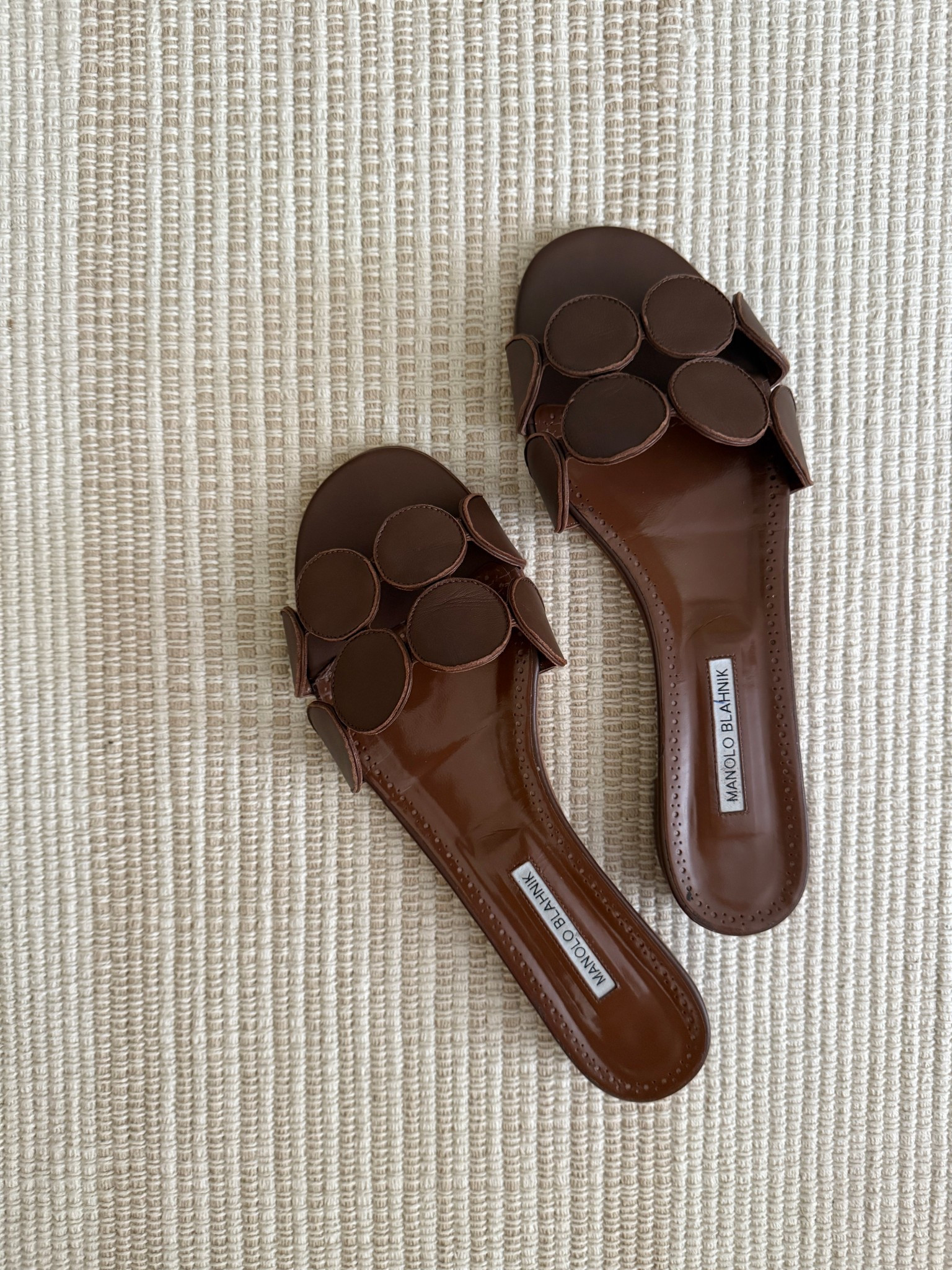 Brown leather flat sandals // Manolo Blahnik Circle-Cut Leather Flat Sandals. 
Sizing: run big, size down 1/2 size from your usual Manolo size. 
#shoes #preppy #classic 

#LTKSeasonal