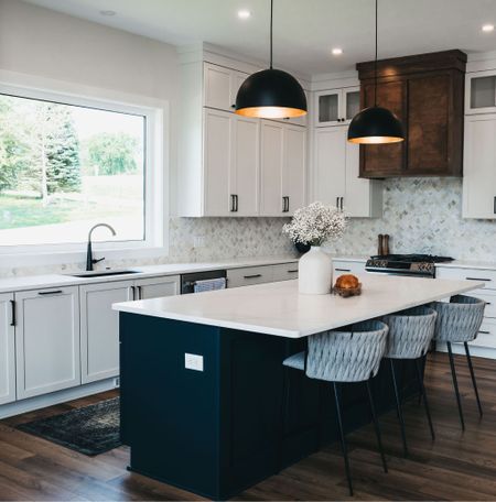Bright and moody kitchen with accent island. Counter stools, pendant lights and more from the Sun Valley lake house! 

#LTKhome