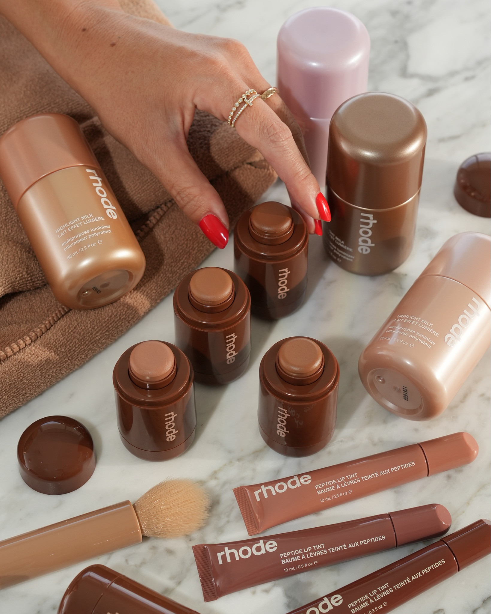 Summer glow perfection with the Rhode Summer '26 launch. ☀️✨ The Pocket Bronzer was the biggest surprise for me! I didn't expect to love it this much, but it's the most effortless cream bronzer I've tried. It blends beautifully, looks very natural, and is almost impossible to overdo.

If you're my skin twin, here's how the shades compare:

🤎 Pebble — the most neutral undertone
💛 Sip — warm golden, but pulls a little yellow on me
☀️ Sunbed — my perfect summer bronze (my favorite)
❤️ Bake — warm reddish undertones for that sun-kissed look

I'm also loving the Highlight Milk Luminizer. I've tried all four shades, and my favorites are Shade 01 and Shade 02. Shade 03 gives my skin a subtle tanned glow, while Shade 04 is a little too deep for me right now but would be beautiful mixed with foundation. The finish is naturally radiant—glowy without looking frosty or glittery.

And I couldn't resist the limited-edition Peptide Lip Tint shades. Every color is a beautiful variation of the perfect tan nude. 🤎 I'm really hoping Rhode restocks them—or even better, makes them permanent.

Which Pocket Bronzer shade do you have your eye on? 👇

#LTKBeauty