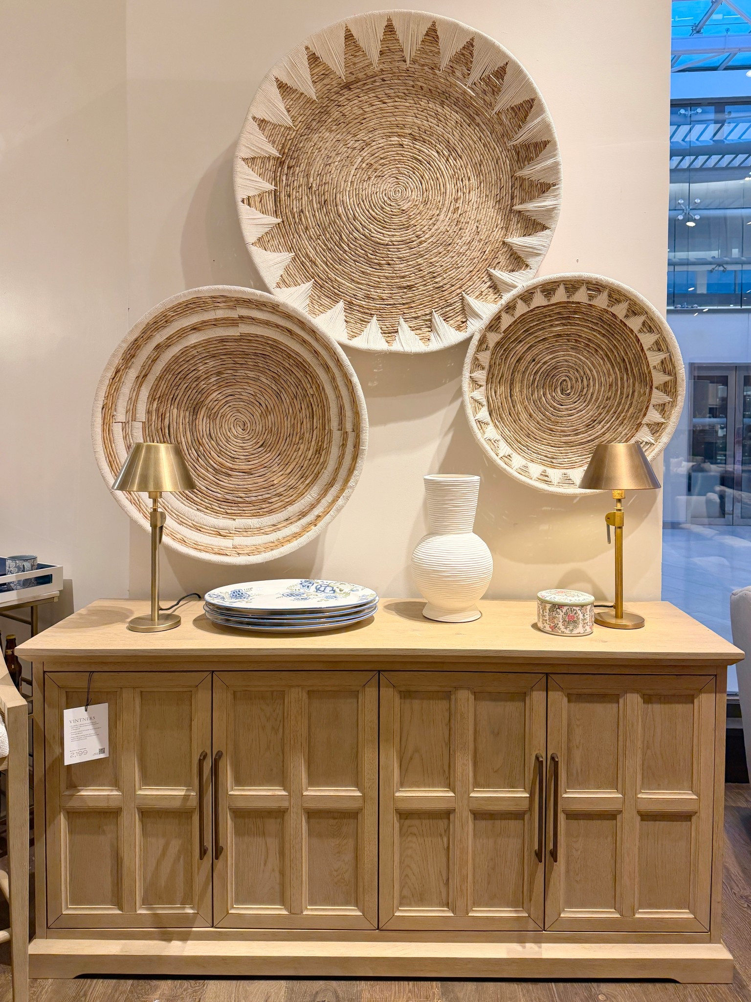 The Vintners Buffet from Pottery Barn brings depth and warmth with its rich Savanna finish and tailored geometric doors. 🤎 The antique brass hardware adds a refined touch, while the concealed storage keeps everything seamlessly tucked away. ✨ Styled with the Sunny Handwoven Basket Wall Art above, this setup feels layered, intentional, and beautifully balanced! ☺️ #potterybarn #sideboard #credenza

#LTKHome #LTKSaleAlert