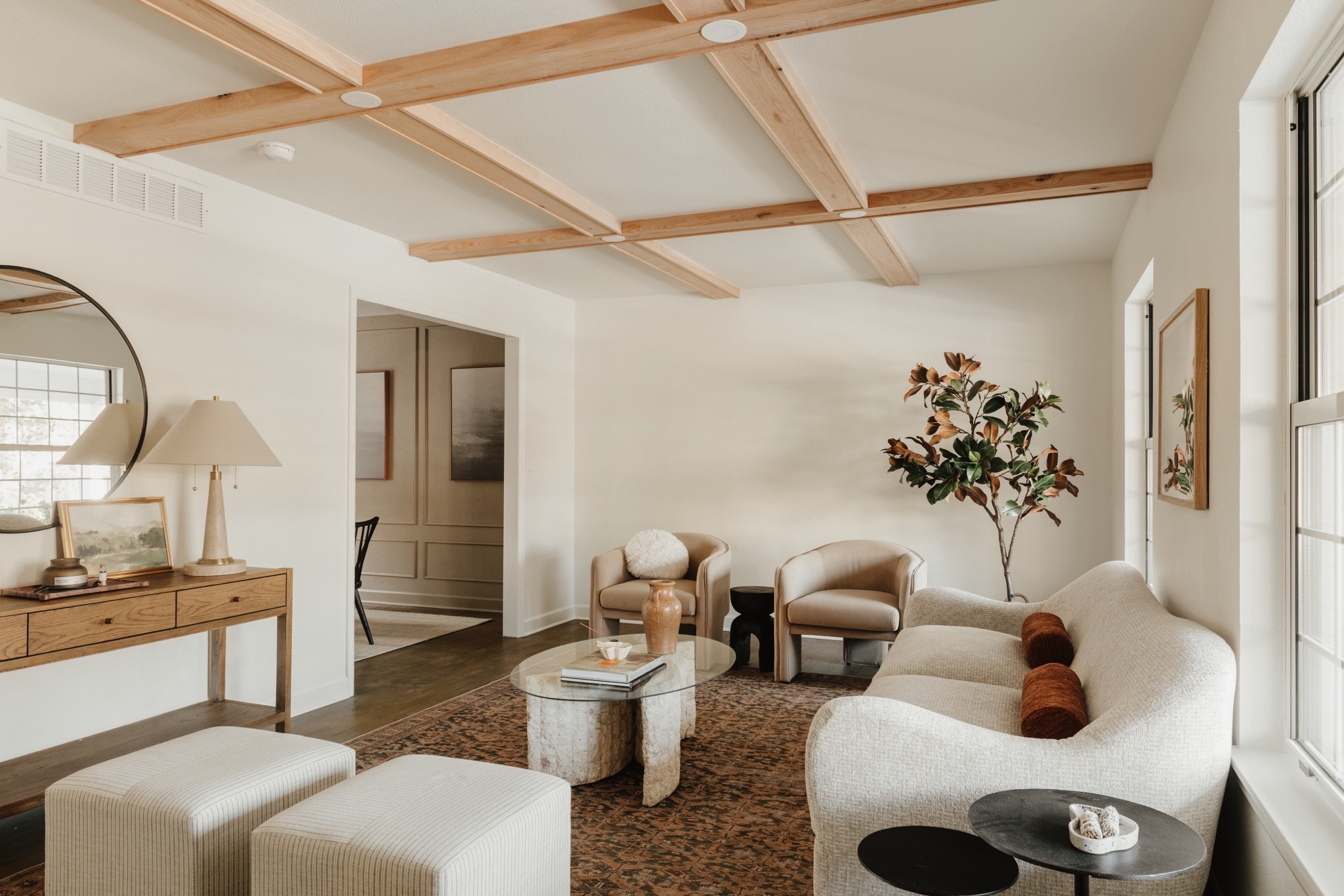 A vintage-inspired earthy rug, camel accent chairs, upholstered ottomans, and a warm oak console come together to create a living room 

Living, rug, vintage, chair, side table

#LTKHome