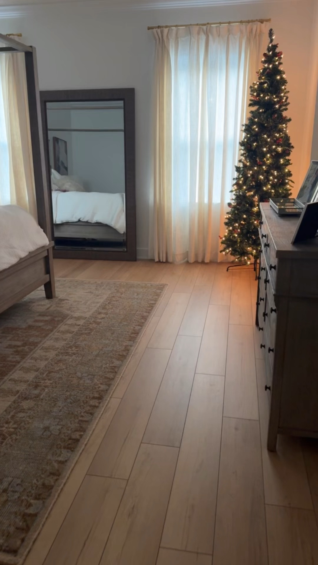 Amazon Christmas tree - 7.5 ft slim and perfect for our bedroom! Neutral bedroom. Pottery Barn canopy bed. Amazon curtains in ‘ivory white’, 52”x96” and look so expensive! Pottery Barn light. Pottery barn rug. Target lamps. Bedroom decor. White bedding. 

*Floors are Calypso Oak by Coretec and paint is Extra White by Sherwin Williams

#LTKSeasonal #LTKHome #LTKHoliday