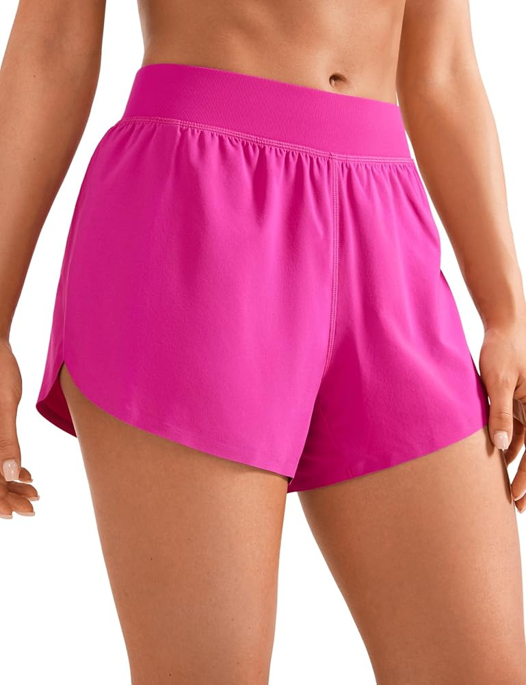 CRZ YOGA Mid Waisted Dolphin Athletic Shorts for Women 4" Lightweight High Split for Gym Workout ... | Amazon (US)