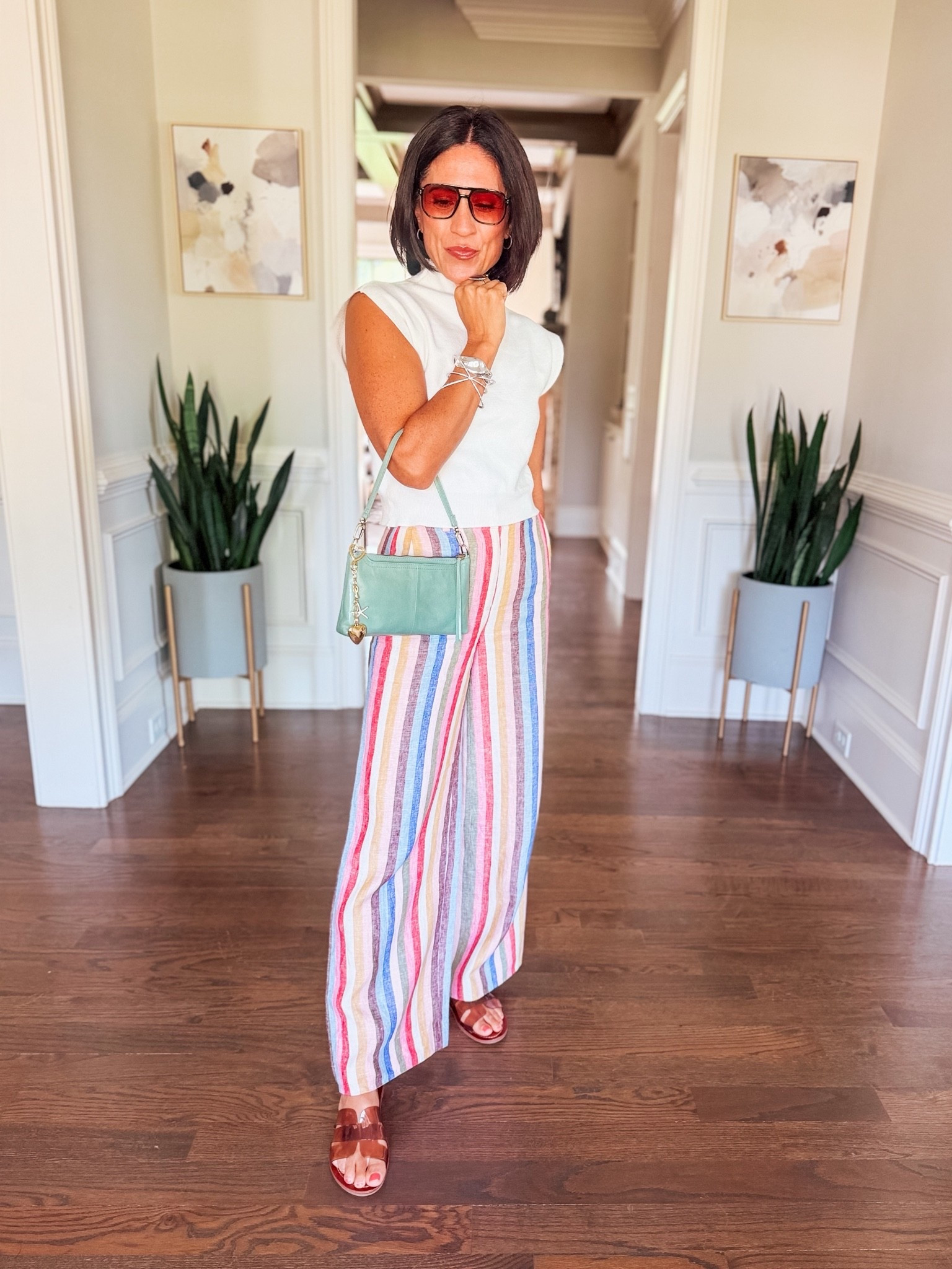 Colorful pants always make me smile. 🌈✨ These rainbow stripe wide-leg pants are the statement piece, so I paired them with a classic white sleeveless sweater, comfy summer sandals, a pop of green, and my favorite bag charm stack for a fun finishing touch. Easy, polished, and perfect for everything from brunch to errands.

Linked what I could here in my LTK! 💚



#LTKStyle #WideLegPants #SummerStyle #ColorfulFashion #Over40Style #EffortlessStyle #StatementPants #EverydayStyle #VacationOutfit #OOTD #MomStyle #ColorfulCloset #ChicStyle #ShopMyLook #LTKFinds

#LTKootd #LTKmomlife #LTKOver40