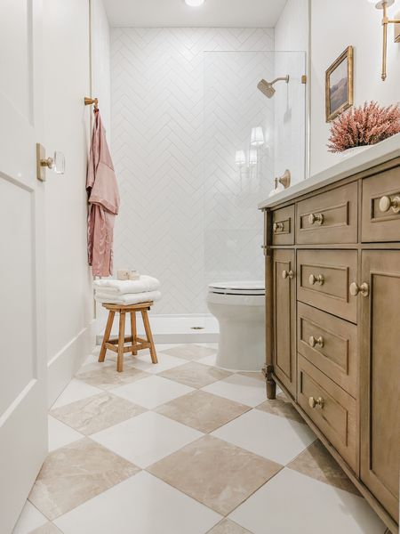 Love this checkered tile to break up the monotony of white in the bathroom. It is appealing to the eye and ties into my wood vanity 

Home design, guest bathroom, bathroom refresh, style inspo, light and bright, pops of pink for the fall, creamy whites, warm wood tones, neutral home, gold detail, home refresh, bathroom info, guest bath finds, Wayfair, Michaels, Amazon, Target, Home Depot, At Home, aesthetic home, faux florals, vanity finds, gold fixture, shower glass panel, pink robe, home decor, bath detail, shop the look!

#LTKhome #LTKSeasonal #LTKstyletip