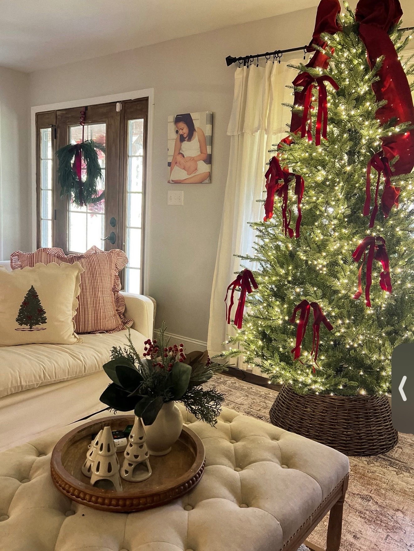 Cozy Christmas decorating with a touch of traditional charm! 🎄❤️ Loving the rich burgundy velvet bows, warm twinkle lights, natural cedar greenery, and woven tree collar. The mix of classic Christmas reds, soft neutrals, and rustic textures makes this living room feel so warm and inviting! Sharing my favorite Christmas tree decorations, holiday pillows, and cozy home decor finds. Shop the look on LTK! ✨