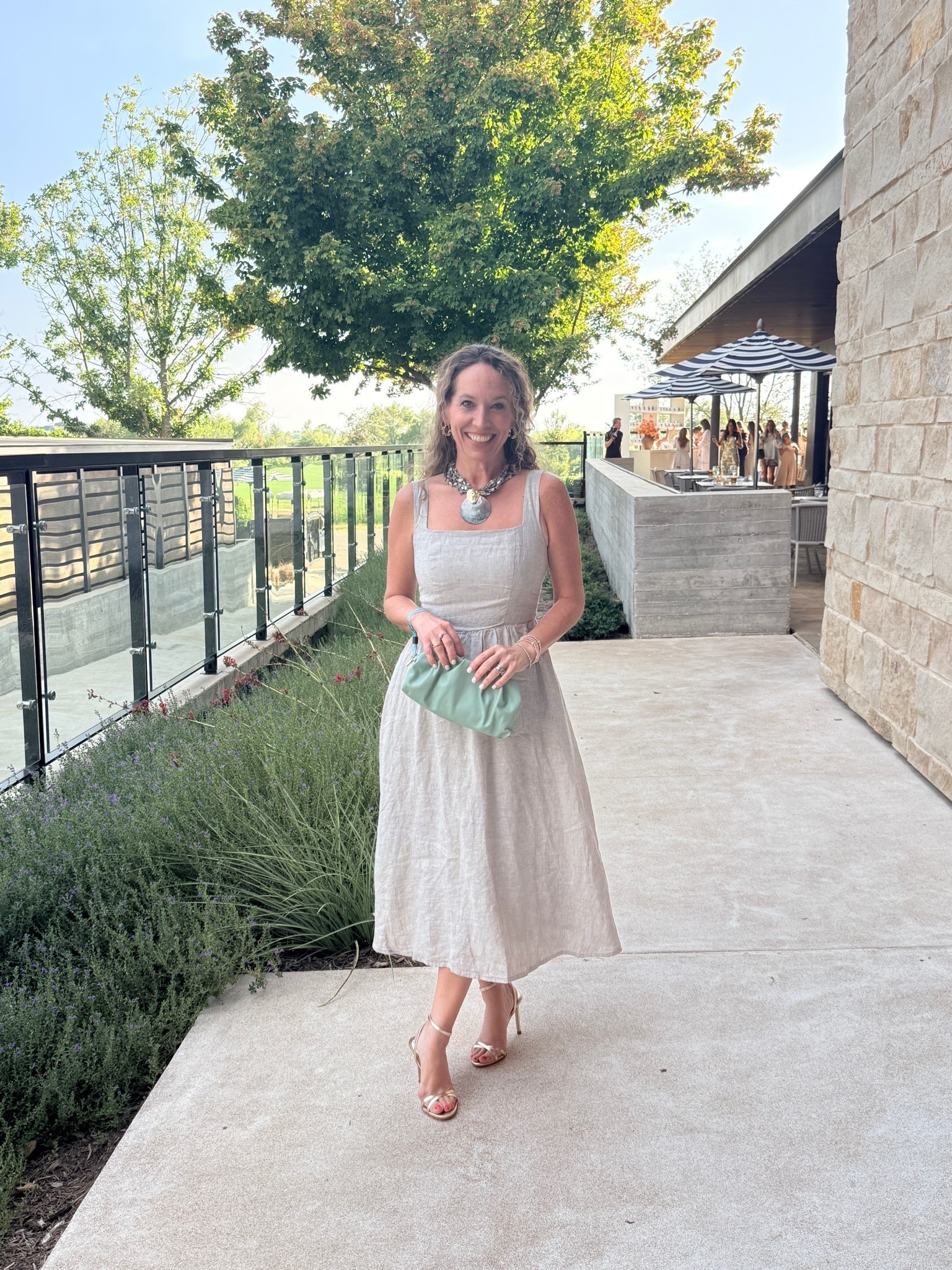 Quince cocktail party!  And of course I wore Quince!  This linen dress is so pretty and you can dress it up or down!  Add a sweater for arm coverage!  I'm wearing an XS.  The linen fabric has a little shimmer to it that makes it super special!  Added pop of green with the necklace and clutch!  Finished look with gold heels!

#LTKCon #LTKOver40 #LTKPetite