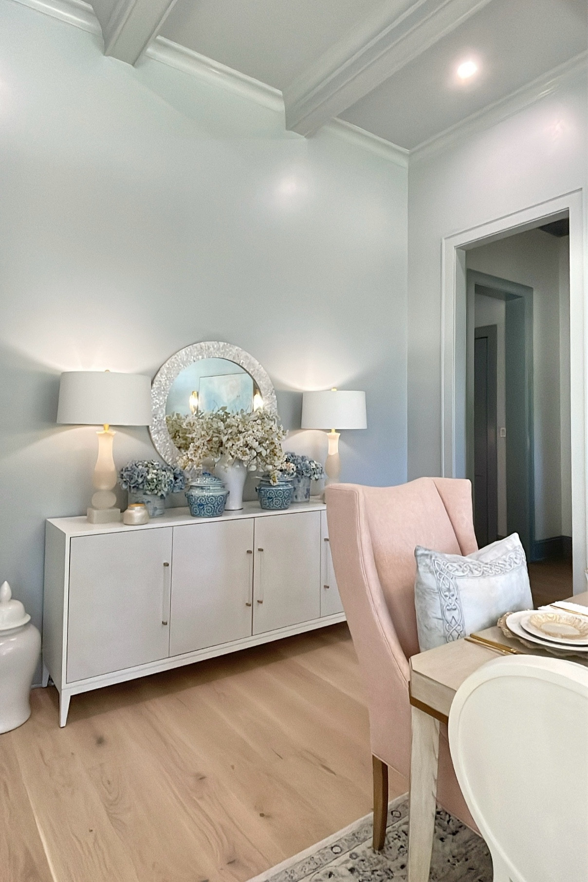 Dining room reveal on Decor Gold Designs! This beautiful console is from our previous home. I still love it just as much as when I got it! Tons of storage! I stayed it with a round mirror, blue and white planters, alabaster lamps, and faux stems

#LTKhome