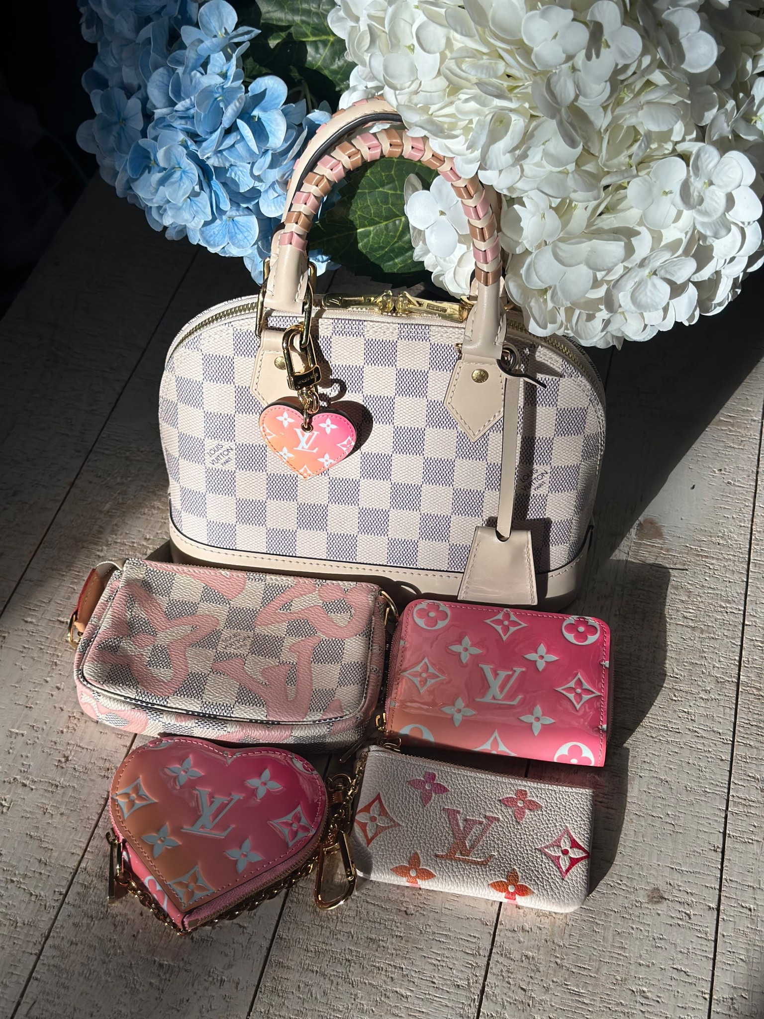 Happy Thursday! Continuing on the winter white theme with my Alma BB in Damier Azur, with my Tahitienne mini Pochette, degrade heart charm, zippy coin and heart coin as well as the sunset key cles. 

#LTKSeasonal #LTKValentine #LTKOver40