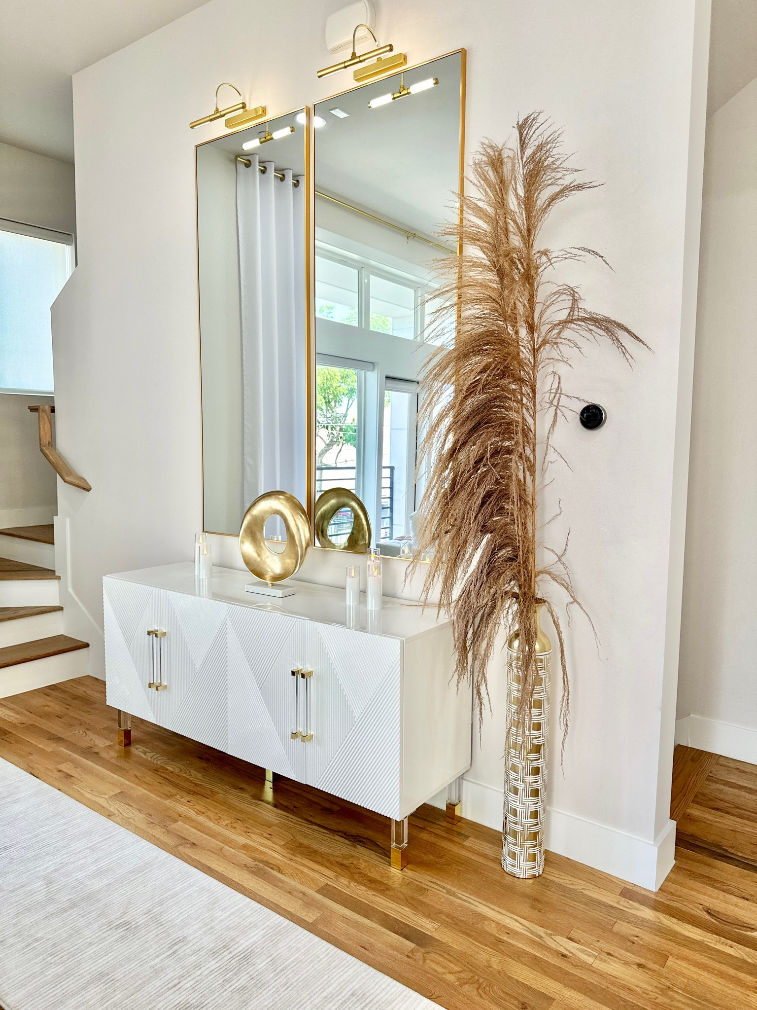 Sideboard • Mirrors • Vase • Pampas • Picture Lights • Rug Runner • Sculpture #homdecor #interiordesign

#LTKhome #LTKstyletip #LTKFind