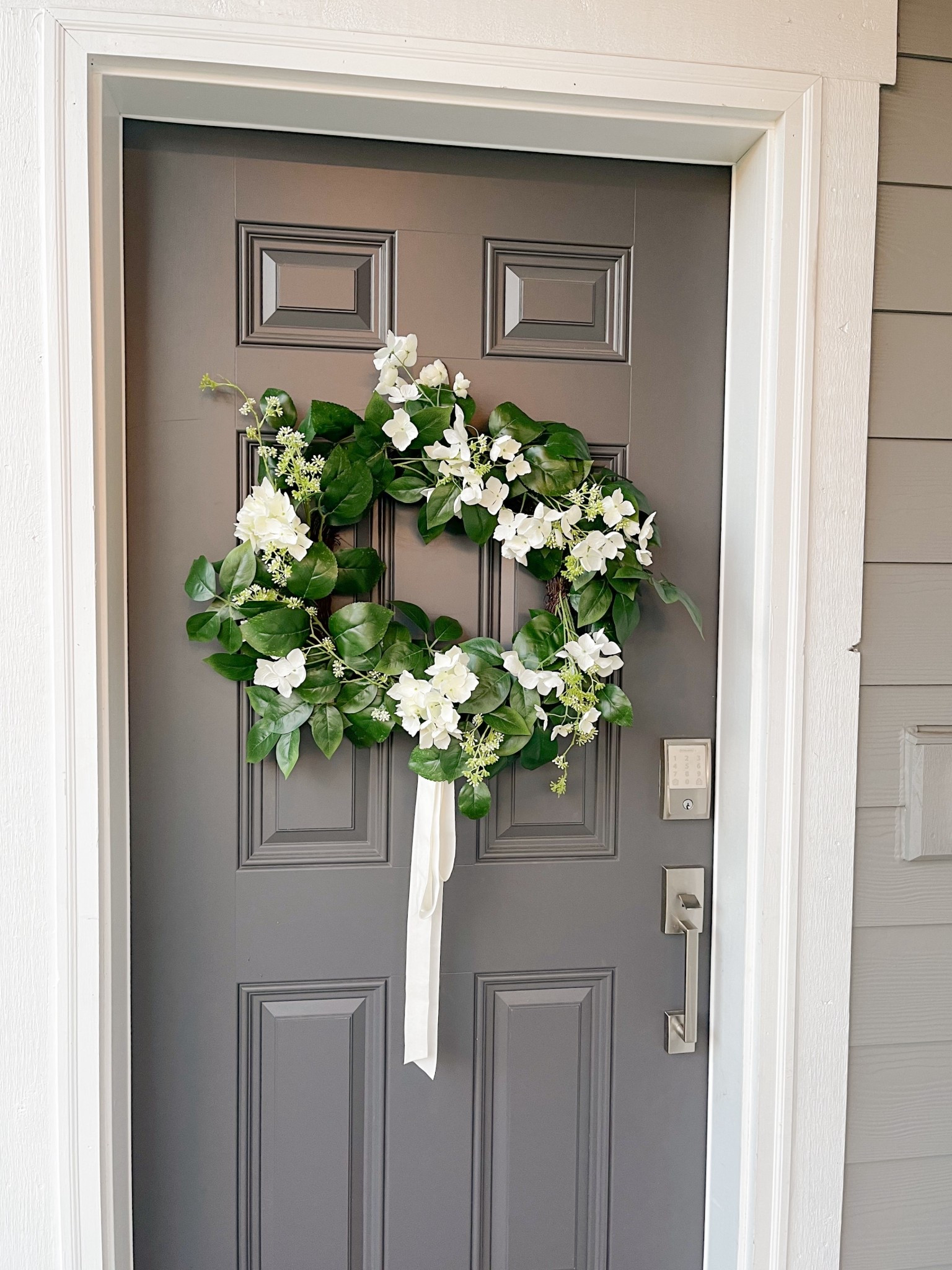 A fresh front door moment 🌿🤍 Mixed greenery + white hydrangea wreath finished with velvet ribbon—and it’s from Target on sale right now! Linking it while it lasts ✨

#FebruaryDecor #WinterToSpring #LateWinterDecor #FebruaryHome #SeasonalRefresh #FrontDoorStyle #WreathInspo #HydrangeaDecor #NeutralDecorStyle #CozyHomeVibes #TargetHomeFinds #TargetStyle #LTKHome #LTKSaleAlert #CurbAppealIdeas #EntrywayDecor #WinterHomeStyle #SpringTransitionDecor #AtHomeWithElke

#LTKHome #LTKSaleAlert