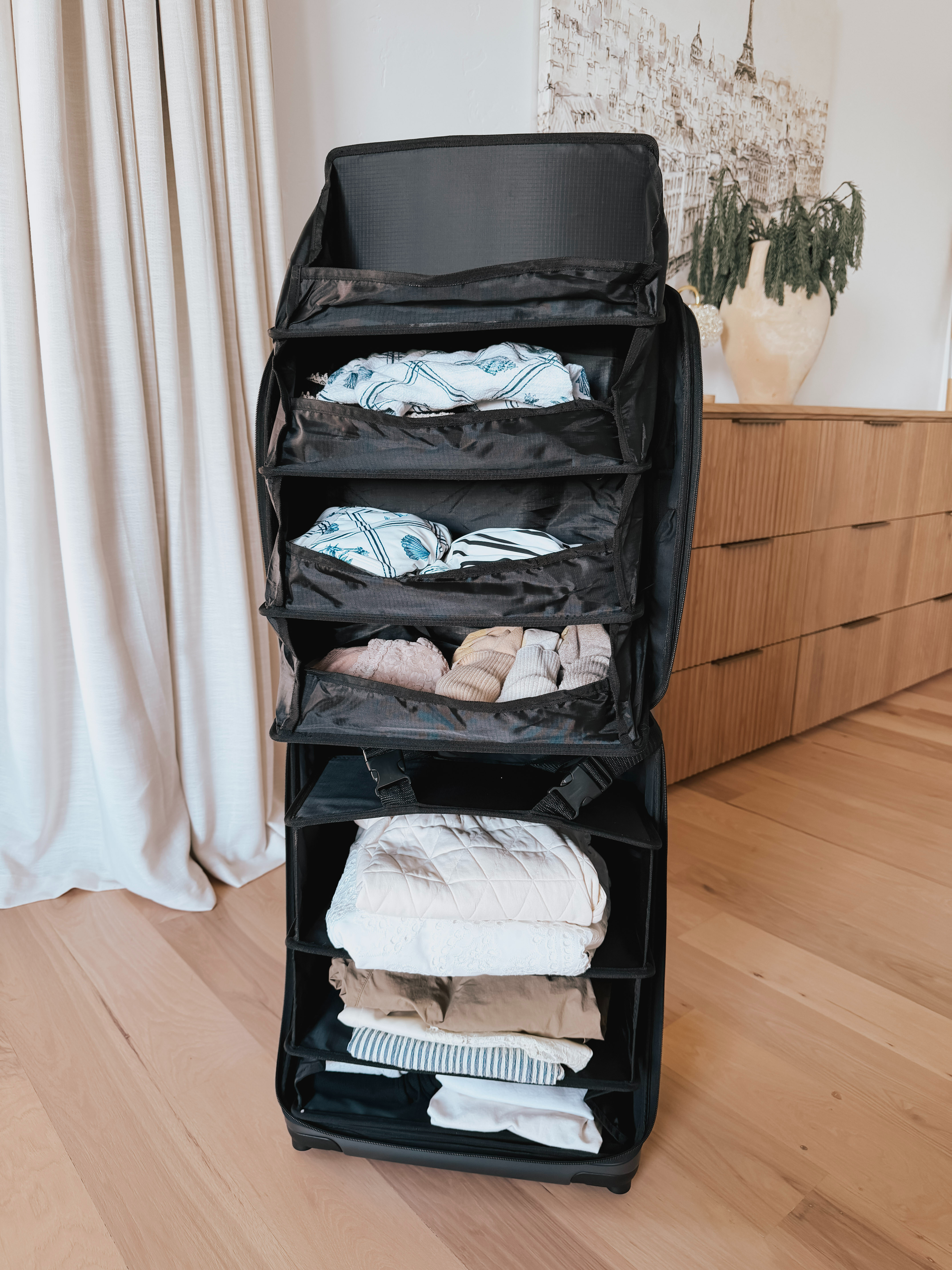 The FLIP “The Suitcase That Turns Into a Shelf” 47L Carry-On is designed for travelers who want to stay organized without unpacking everything at each stop. Its standout feature is a built-in shelving system that deploys directly from the suitcase. In short, it’s a hybrid between a suitcase and a portable closet—prioritizing organization and convenience over maximum packing flexibility. 

 #LTKmomlife #LTKActive #LTKTravel