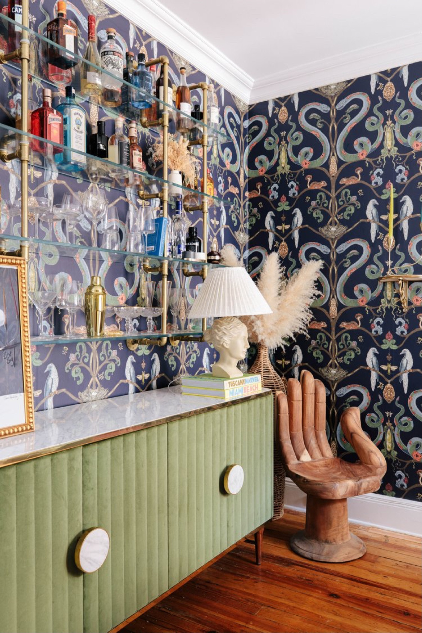 Anthro palm chair, velvet sideboard table, printed wallpaper, glass bar shelving, colorful dining room decor 

#LTKHome