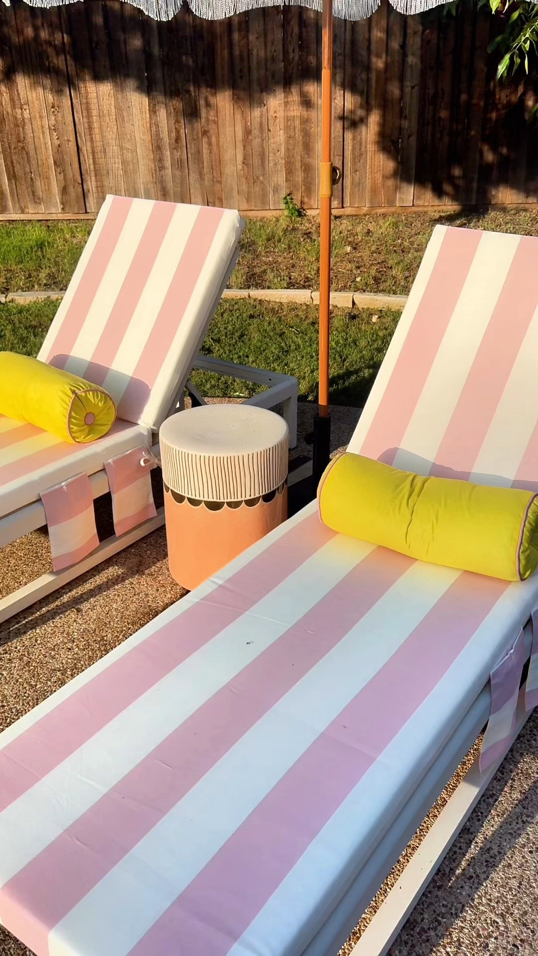 Pink striped lounge chair cushions and a fringe patio umbrella. Very happy outdoor space! 

#LTKHome #LTKSummerEdit #LTKFindsUnder100