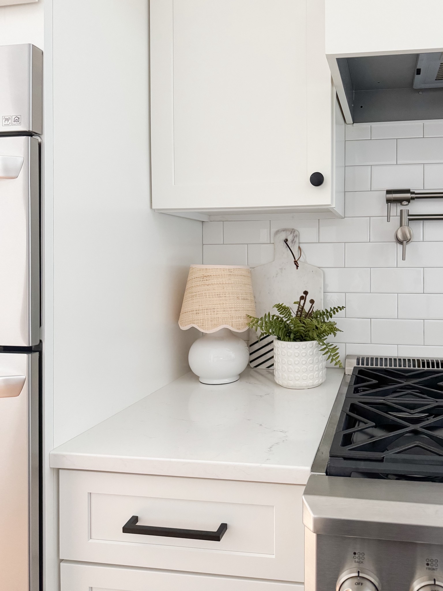 Simple coastal kitchen counter styling with wood boards, oil bottles, and greenery layered in a way that feels intentional but never overdone. A cape cod kitchen moment that balances beauty and function perfectly. Cape cod kitchen styling, coastal kitchen counter decor, wood cutting boards, olive oil bottles, neutral kitchen accessories, amazon finds kitchen styling, sherri calnan home

#LTKHome