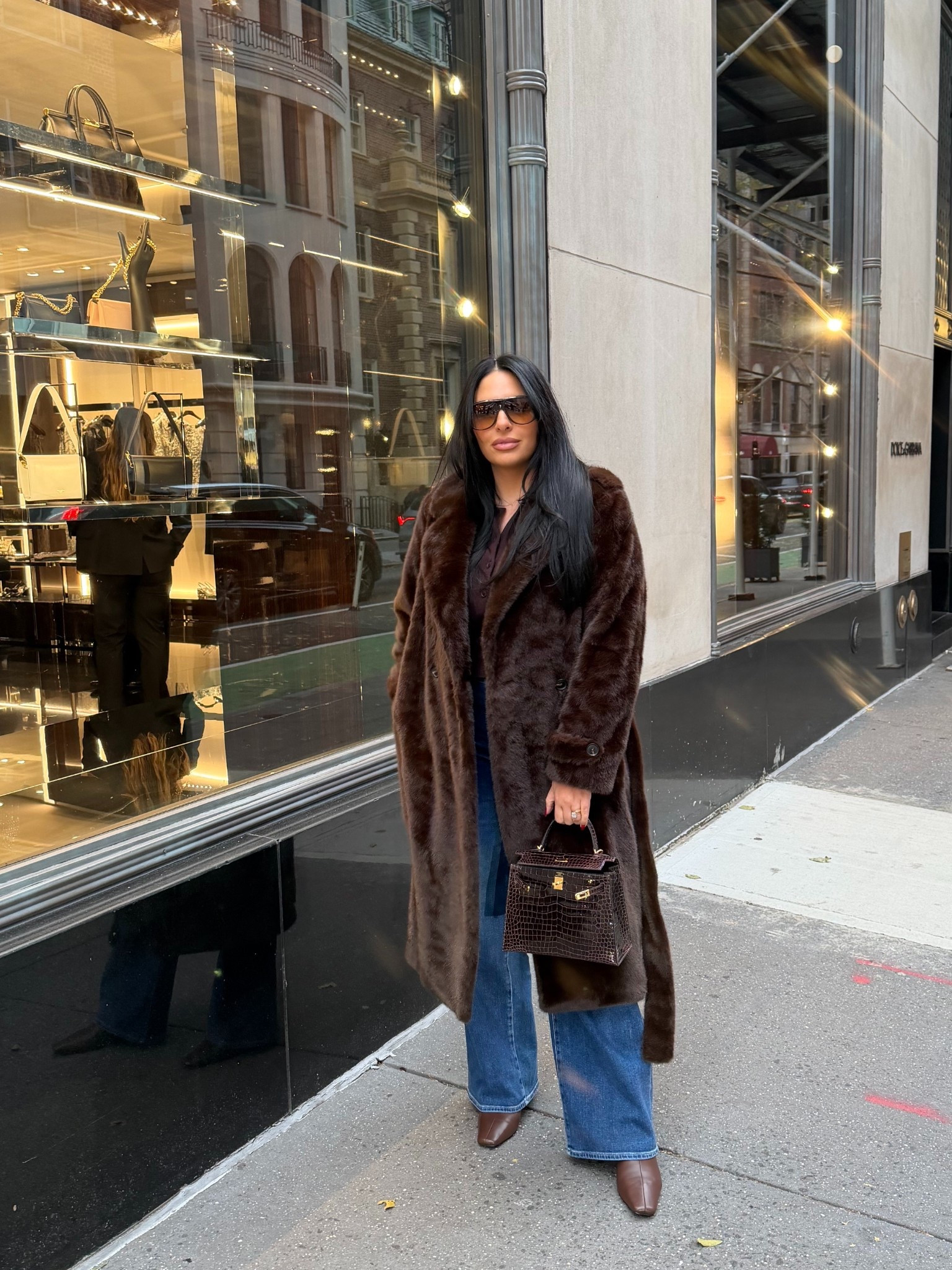 A brown winter 🤎 brown faux fur coat, wide leg jeans, brown sweater, brown boots, brown sunglasses 