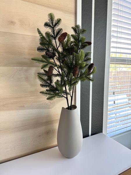 Holiday vase styling using faux pine and pinecone branches in a gray ceramic vase. Christmas dining room decor.

#LTKHoliday #LTKSeasonal #LTKhome