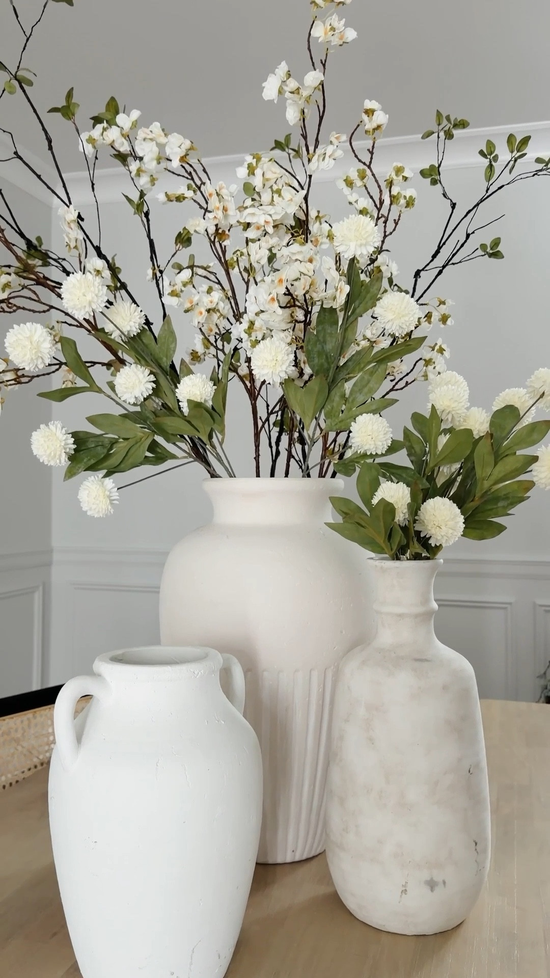 Spring time is my FAVORITE to style & this arrangement made the whole dining space feel instantly fresh 🤍🌿

I mixed a few neutral ceramic vases with faux cherry blossom branches, soft white florals & greenery for that light, airy spring look!

Perfect for a dining table, kitchen island, or entryway if you want your space to feel bright!
Everything I used is linked on my LTK 🫶🏼

spring home decor, spring table decor, faux floral arrangement, neutral home decor, dining table centerpiece, spring centerpiece ideas, neutral vase styling, faux cherry blossom branches, modern farmhouse decor, spring home styling

#LTKSaleAlert #LTKSpringSale #LTKHome