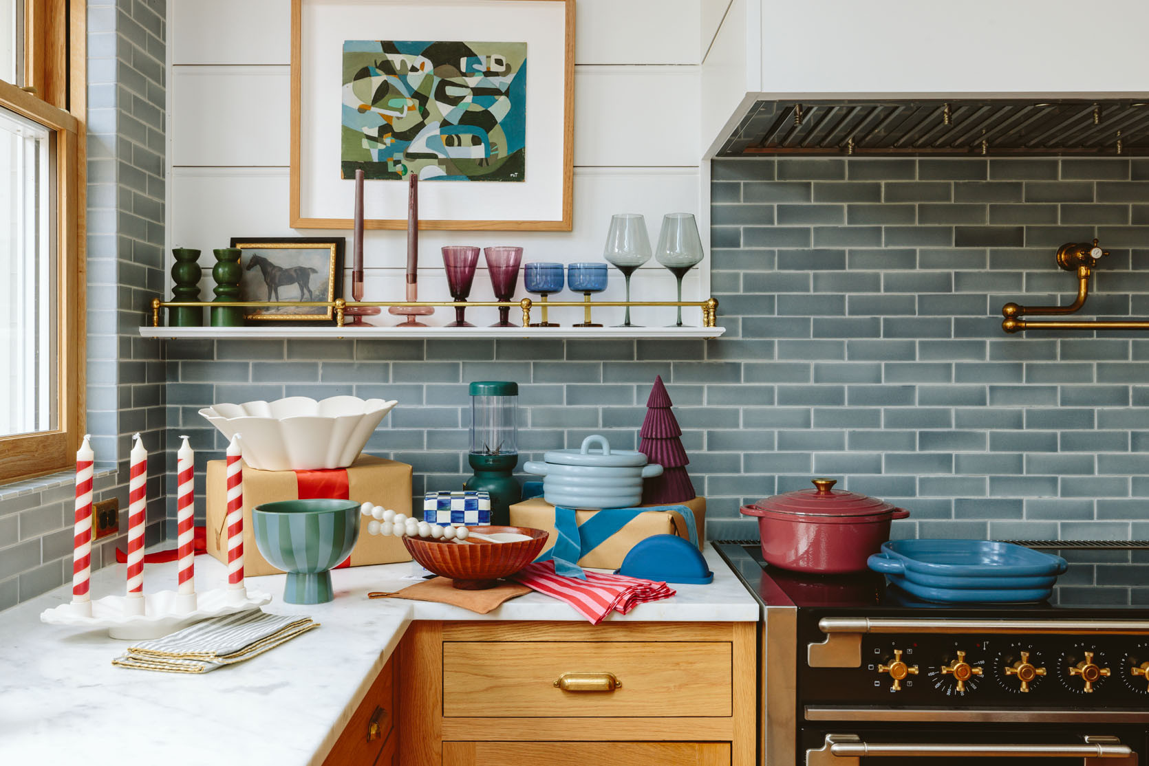 In here I found some pretty awesome stuff for the kitchen that I couldn’t believe how cute and affordable it was – the light blue covered baking dish? SO CUTE (great for sides but also comes bigger in white). The footed blue/green vessel(under $20) and the scallop candle holder (could be year-round on the dining table with nonholiday candles) – both are styling staples. As you can see all of these pieces have something really special about them – either the shape, the texture (the scallop, the round ribbing), or the perfect color.

The red stripe napkins are $3 each and while of course, they are excellent Christmas napkins, red is having such a moment that I’d use it in spring and summer, too. They feel really high quality. The glassware that I collected on the shelves are just better than basic – the two-toned glasses are thick and special (and splurgier) while the purple goblets are affordable and so rich. And don’t forget the $8 glass candle holders – so good, so pretty, so affordable. I have them on my coffee table.

The green blender is countertop worthy (I just bought it for myself and love it), and while that tissue box cover is on the splurgy side it also comes in black and white and it’s metal. Let’s just say it brings me more joy than I originally predicted (I also love the tray version of it and have it on my coffee table).

#LTKGiftGuide #LTKFindsUnder100 #LTKHome