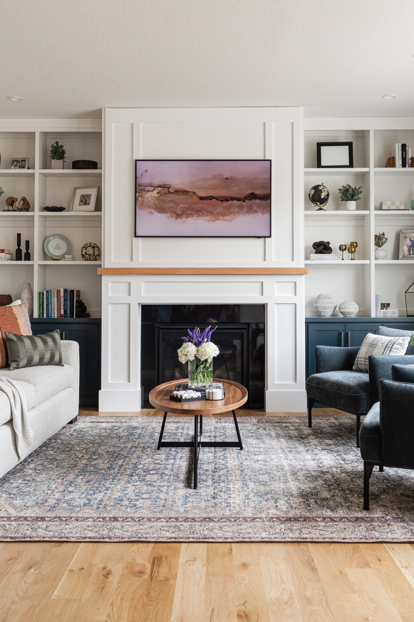 When the client asks for a living room with clean lines and a bit of mid-century flair, paired with teals and blues but grounded in neutrals, this is what you come up with.🤍 The area rug is from my favorite budget friendly brand: Loloi! And the walnut coffee table from @Lulu and Georgia is a best seller because it’s such a show stopper!

#LTKHome #LTKSaleAlert