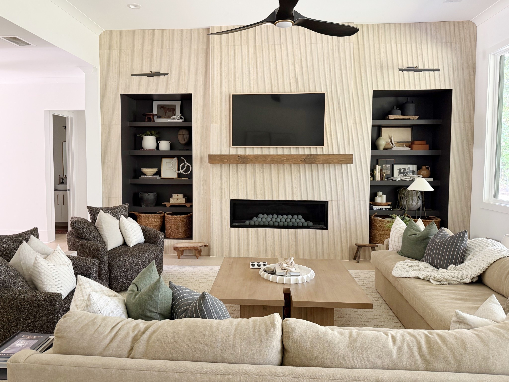 Living room sectional and styles bookshelves with square wooden coffee table, and swivel chairs ✨

#LTKStyleTip #LTKHome