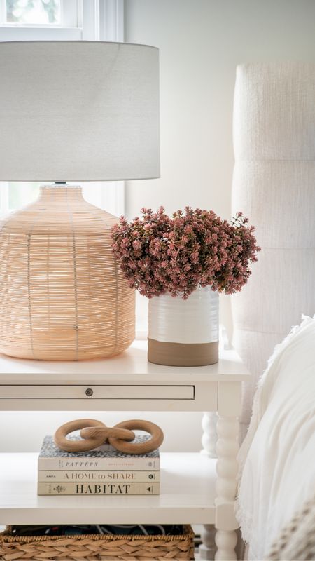 Simple bedroom decor including table lamp, side table, vase, flowers, decorative wooden link

#LTKhome