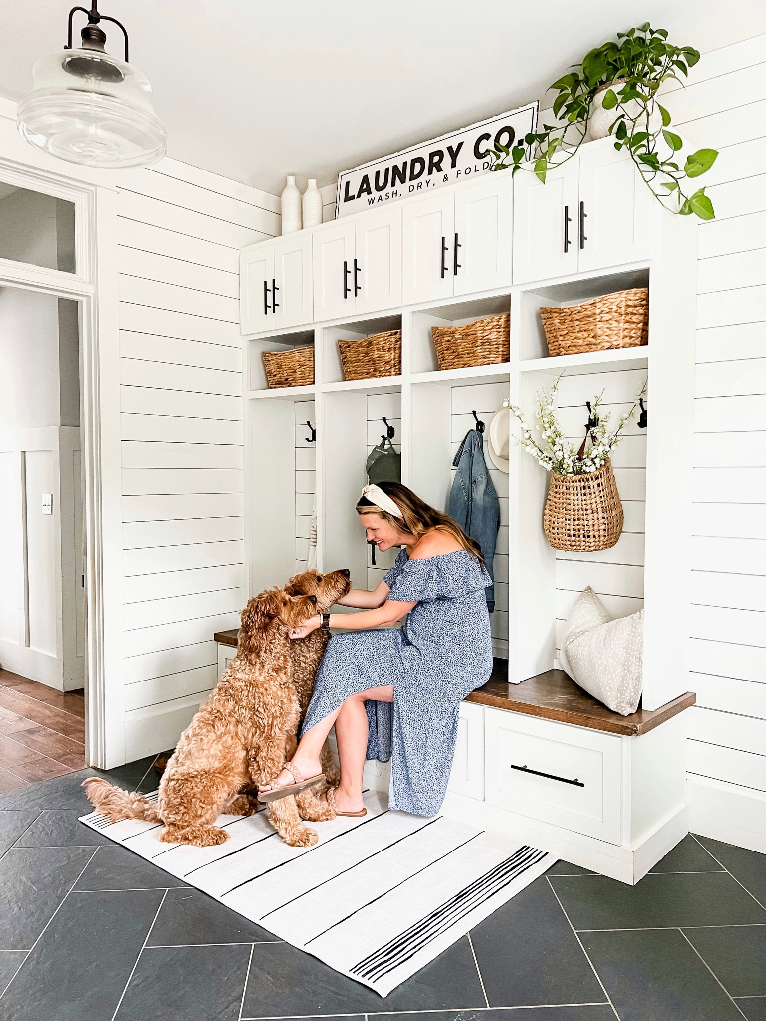 Laundry room and mud room design, modern farmhouse, style, laundry wall, sign, white vases, hyacinth baskets, all basket, hanging basket, white cherry blossom, stems blue, maternity dress, headband, ruggable machine, washable rugs in collaboration and partnership with the home edit white and black throw pillow covers home, decor, accents and accessories

#LTKhome #LTKstyletip #LTKFind