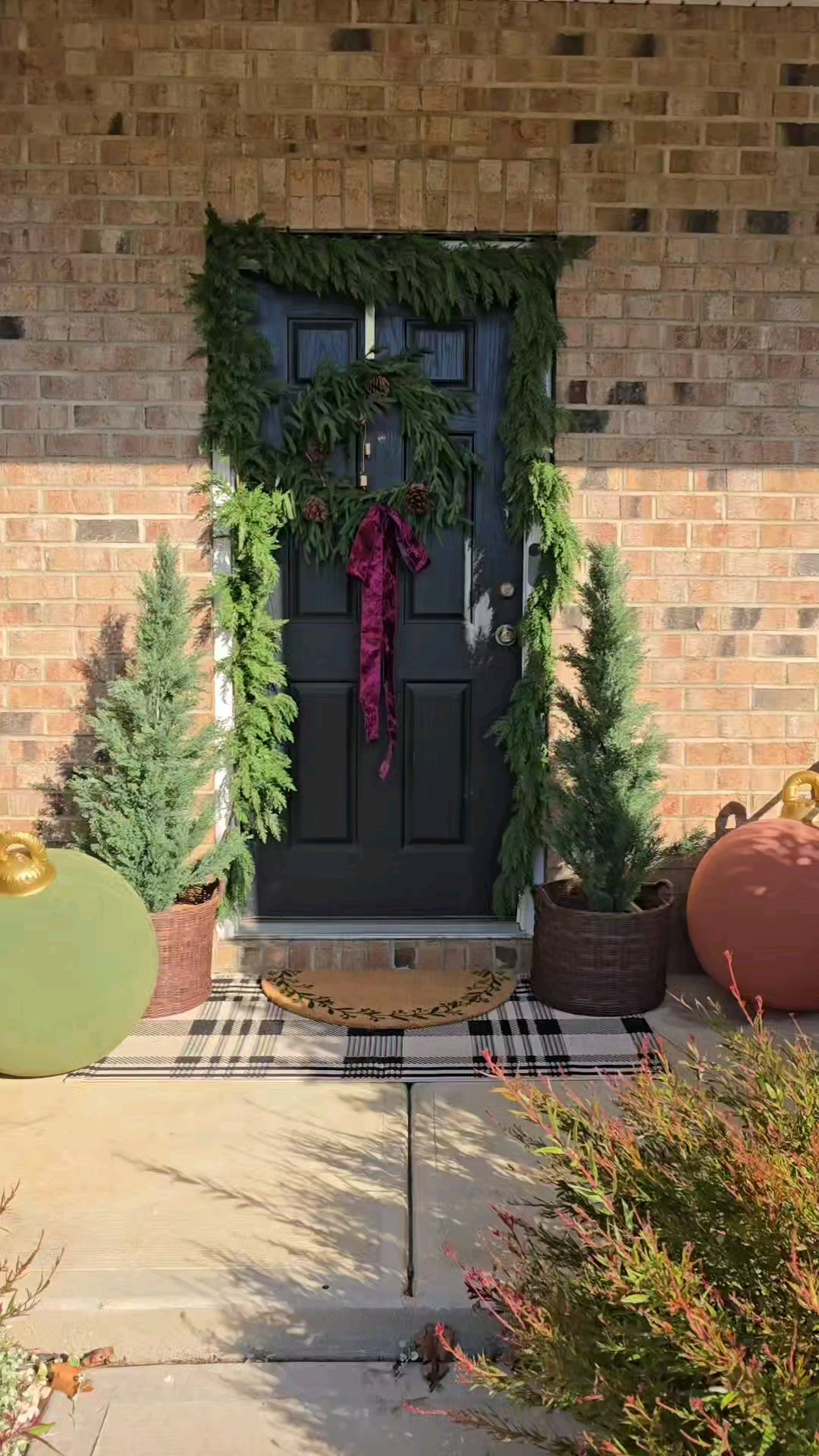 Christmas Porch Styling! Can you believe this is actually just one long Garland? I picked it up from Kirklands and the trees are from Walmart. I tried to link to alternatives to just about everything shown in the video due to availability. The inflatable Christmas ornaments do come with a steak that you can put in the ground to keep them in place. I ended up pushing part of the string underneath the planter, to keep them standing up.

#LTKHoliday #LTKWatchNow #LTKHome