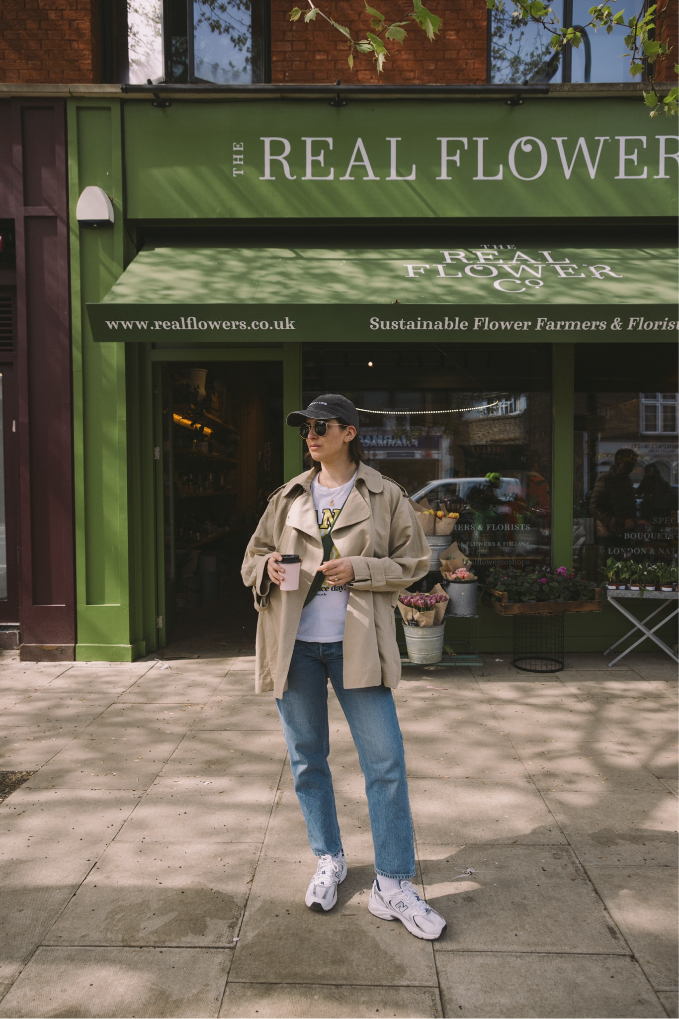 My go-to spring outfit Ganni t-shirt, graphic tee, cropped Arket trench coat, Ray Ban sunglasses, Summer Fridays lip balm, cropped jeans, Uniqlo mini shoulder bag, New Balance 327, summer walk

#LTKuk #LTKspring #LTKeurope