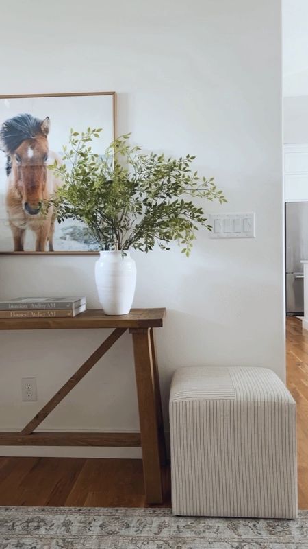 In our entryway I have styled a Target square ottoman next to our wood console table for extra seating. Above the table is an oversized piece of artwork. And on the table I have styled faux stems inside my Amazon vase on one side and a concrete table lamp on the other  

#LTKFind #LTKhome #LTKstyletip