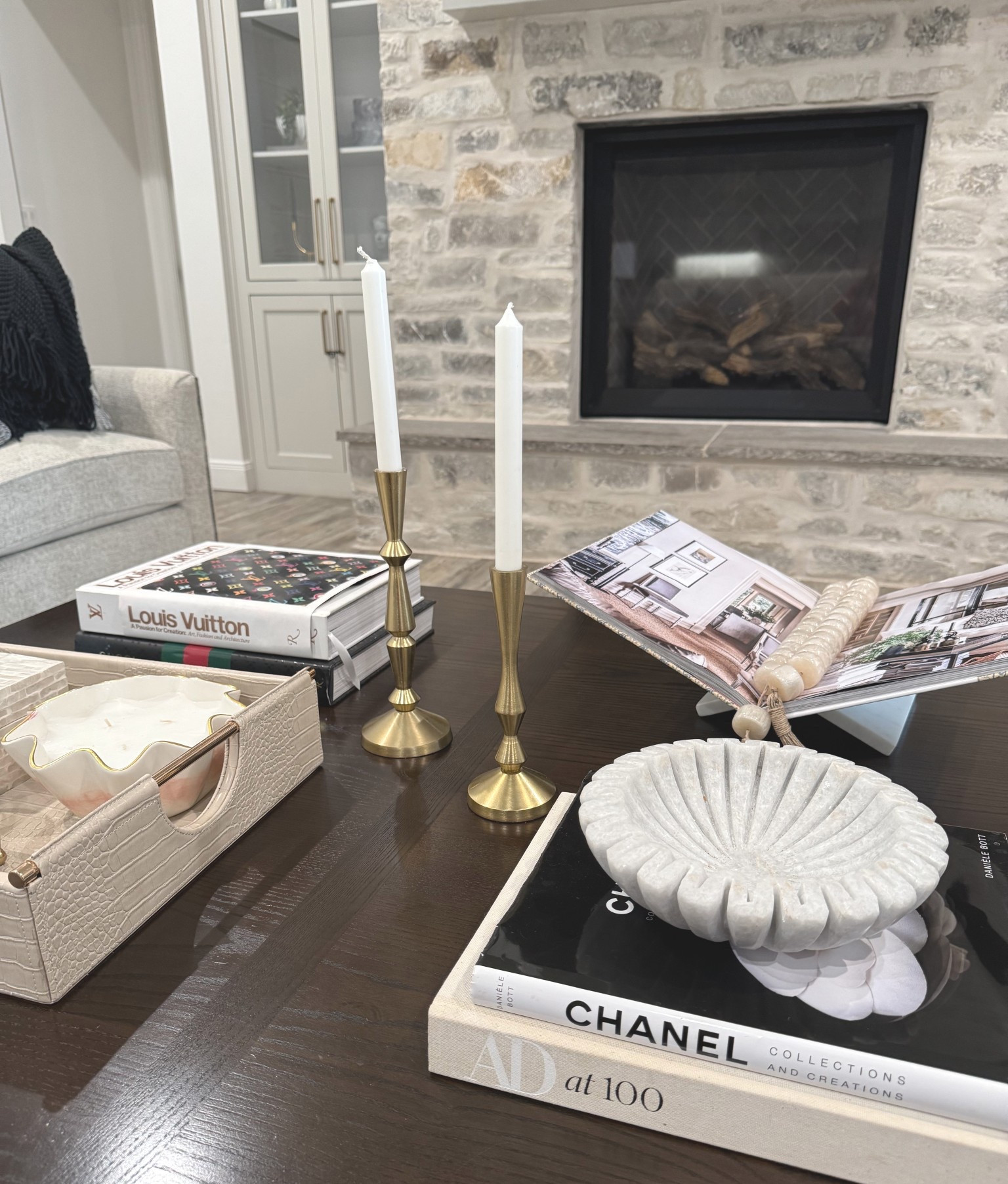 Coffee table decor. Candle holders, decorative tray, small picture frame, candle, decorative box, marble decorative dish, Chanel coffee table book, AD at 100 coffee table book, Louis Vuitton A Passion for Creation coffee table book, Gucci coffee table book, marble book display. Amazon. World Market

#LTKFindsUnder50 #LTKHome #LTKFindsUnder100