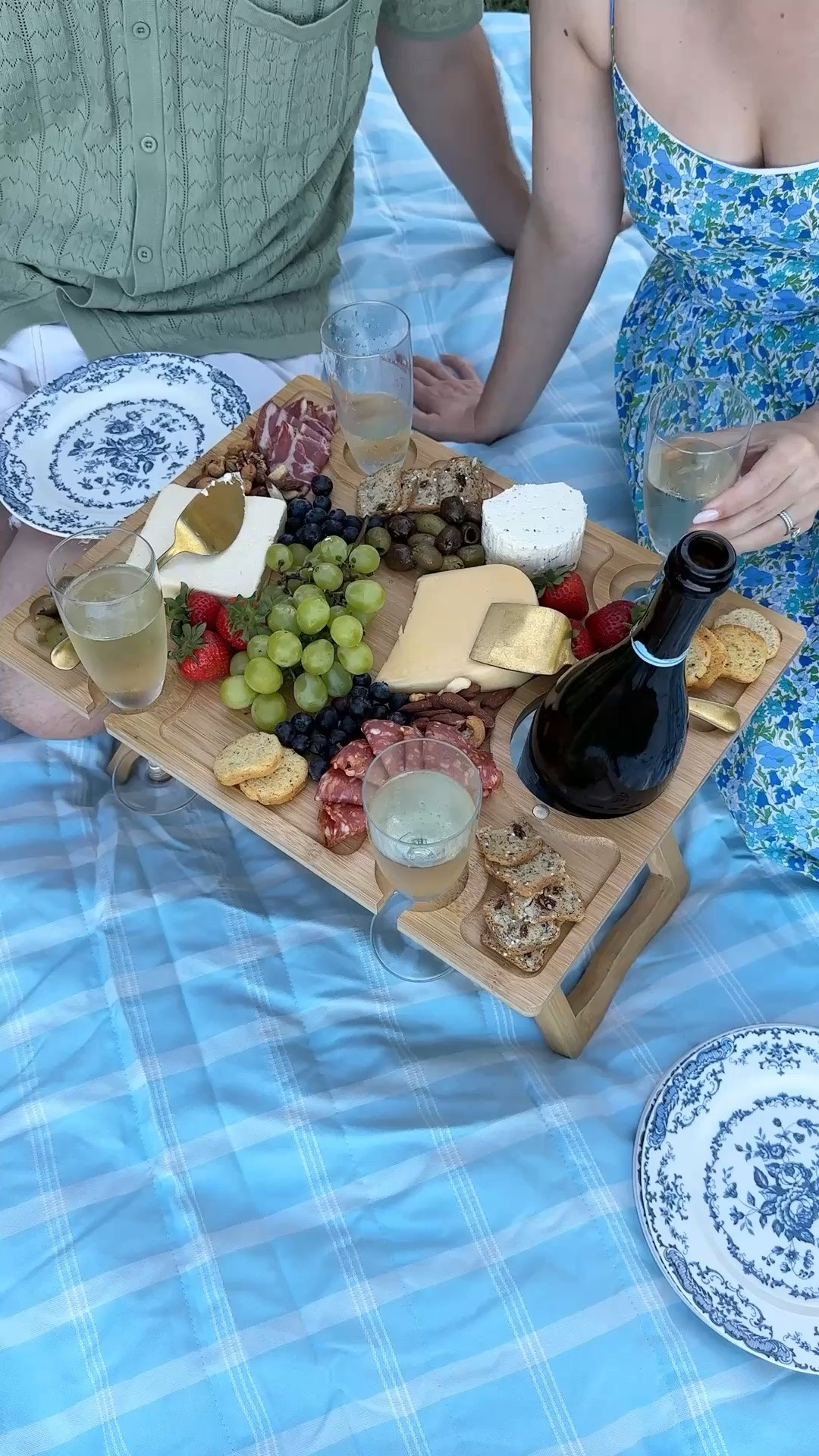 If you're a homebody and just want to spend your day with your loved one at home, this date-at-home inspo is perfect for you! Set up a charcuterie picnic table, and ceramic plates, and your favorite wine over a waterproof outdoor blanket.

picnic life, cozy date, dinner for two, wine and dine, food styling, hostess essentials, outdoor activity, garden picnic