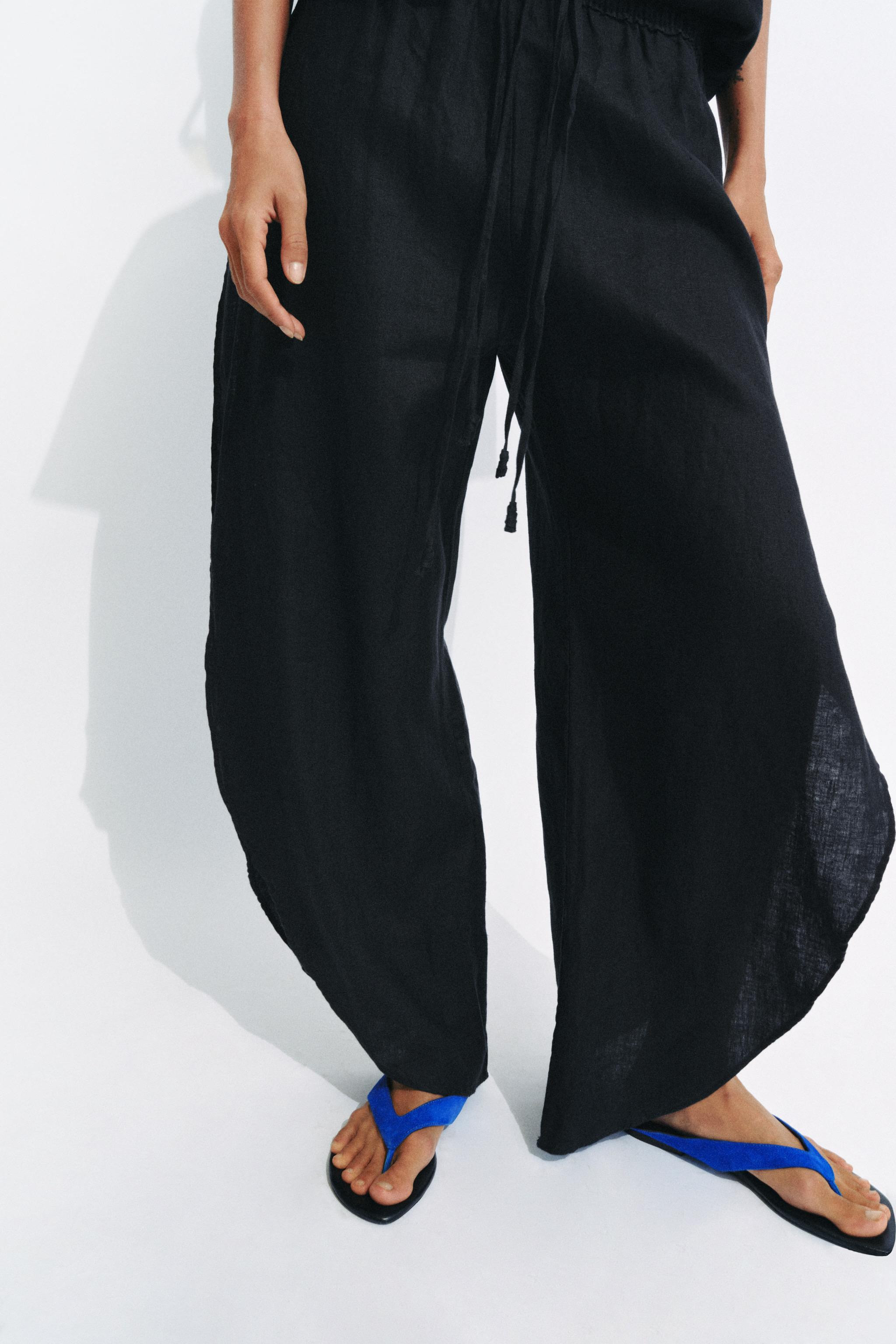 ZARA WOMAN COLLECTIONTrousers with a main fabric made of 100% linen. Featuring a mid-waist and an... | Zara UK