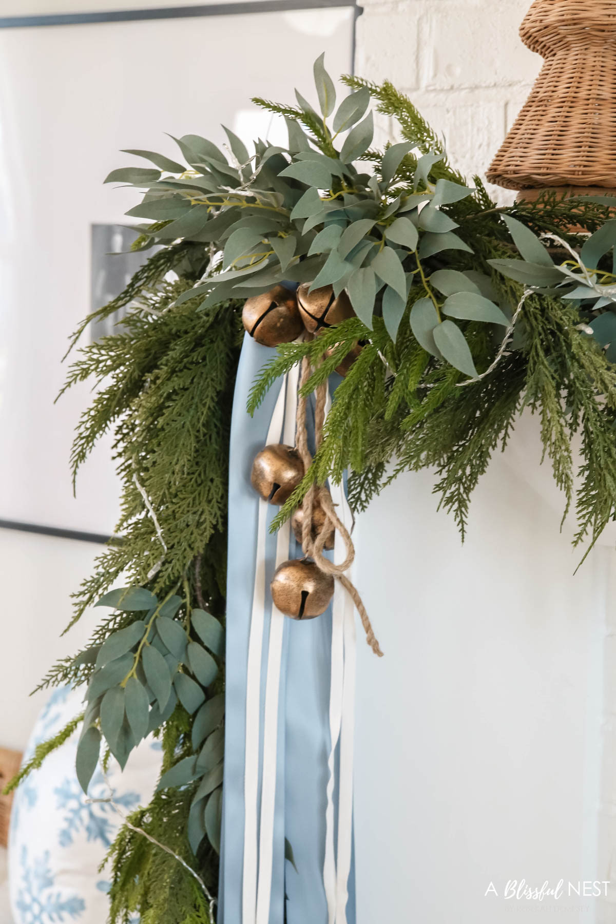 A little close-up of my last year's mantel decor. Get them while they last.
Norfolk pine Christmas garland, dusty blue satin ribbon, ivory velvet ribbon, vintage cluster cow bells on rope, fairy lights 

 #LTKHoliday #LTKSeasonal #LTKHome