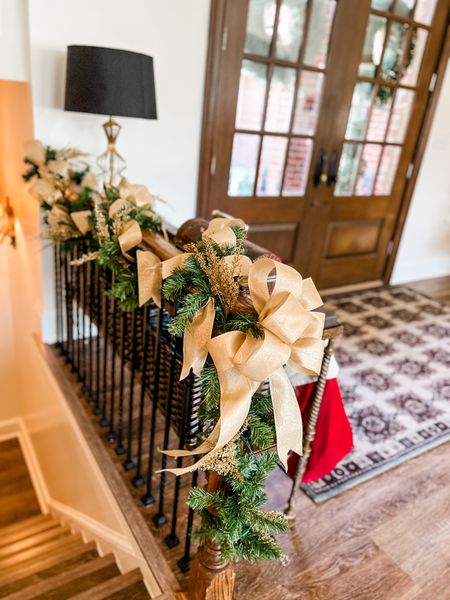 Simple. That’s my middle name. Coordinate your garland using the garland you’ve had packed away for 11 months by adding touches from items you’ve used in your tree. I promise it will look great once it’s fluffed and embellished. 

Add in picks using an odd number. I used only 9 for this bannister.  Secure with branches. 

Pop in ribbon and trailing tails. I used 1 loop bows, securing the now with wire and the trails with the branches from the garland.  For the newel post, I made a larger 7 loop bow to finish it off. 

#traditionalchristmas #goldchristmas #simpledecorating

#LTKSeasonal #LTKHoliday #LTKhome