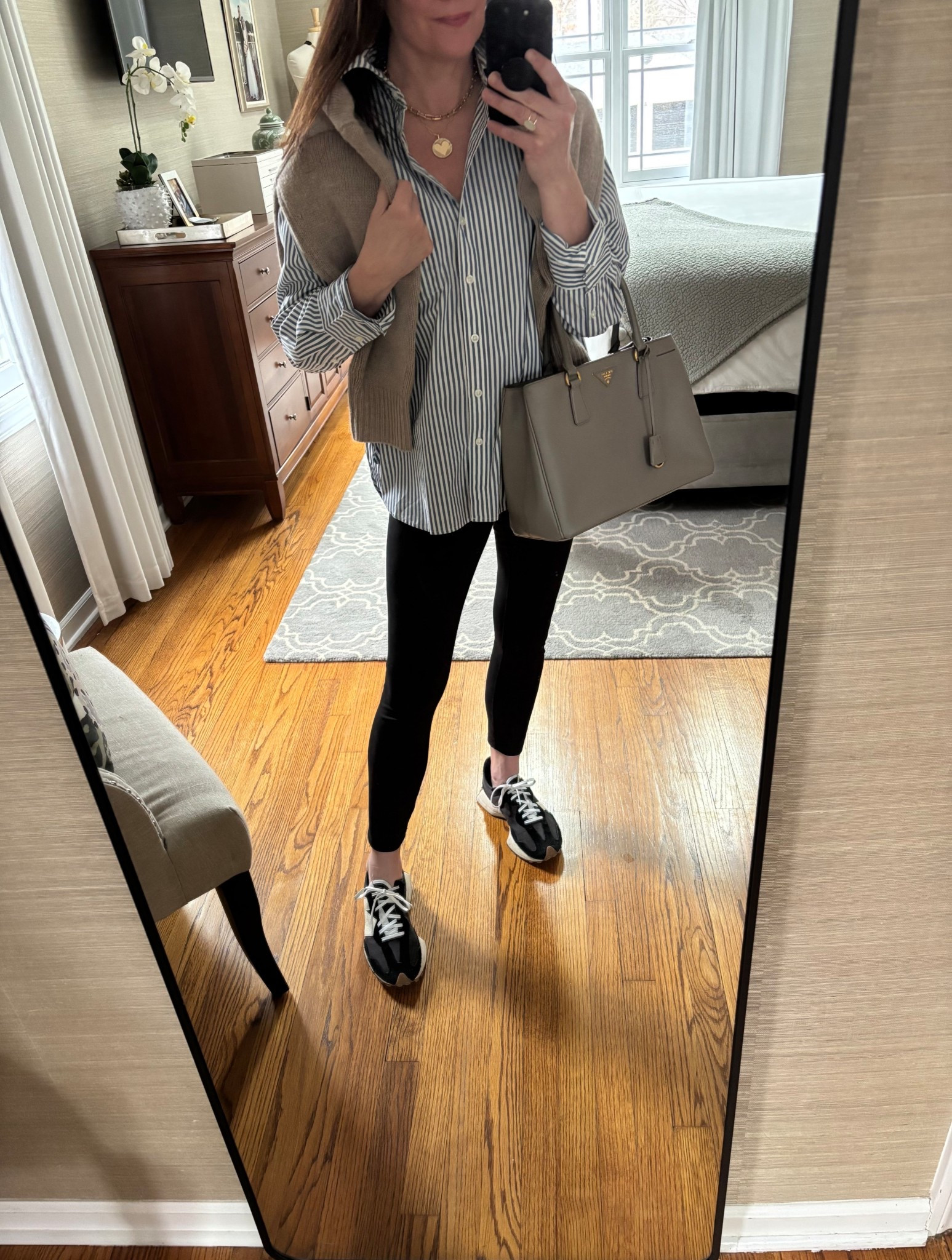 This striped button down shirt is perfectly oversized and can be worn so many ways! Pairing it here with leggings, sweater thrown over the shoulders and sneakers. It’s $70 and available in stripes and solid colors! 