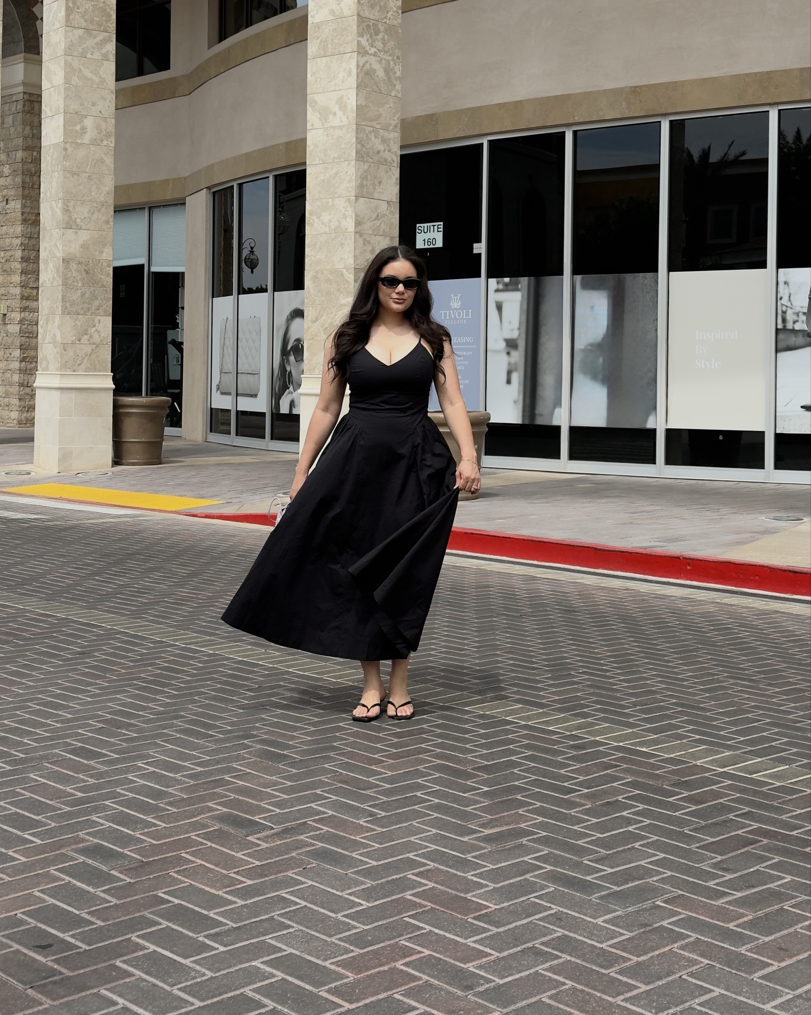 Effortless chic for a sunny stroll ☀️🖤 A little black dress, strappy heels, and a pop of pastel — keeping it timeless, always. 