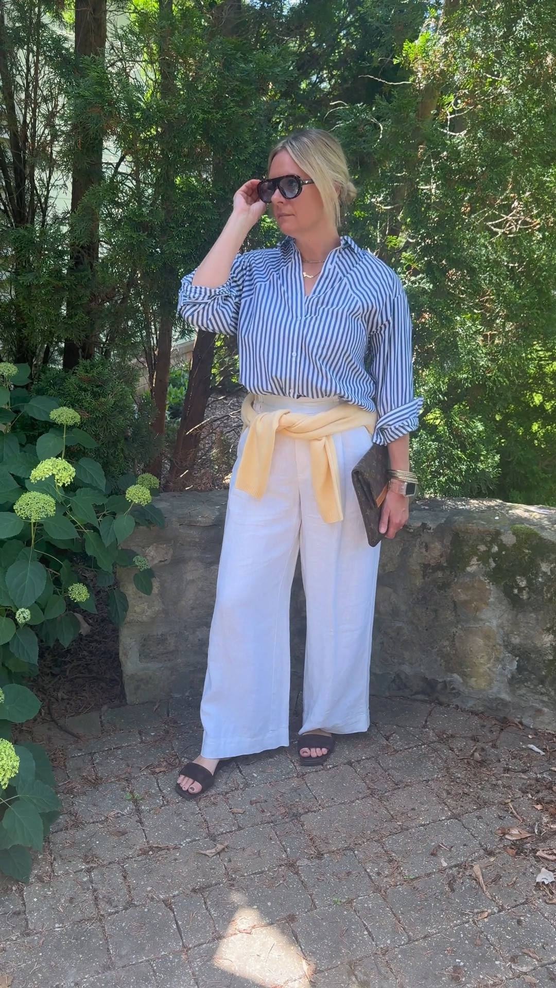 OOTD before heading out for a client personal shopping appointment ✨ Blue and white striped shirt + white wide leg linen pants + yellow cardigan tied at the waist + brown suede slide sandals + layered necklaces + blue lens sunglasses. All from my own closet — linked the closest versions I could find. Everything shoppable below! 👇

#LTKdayinmylife #LTKootd #LTKOver40