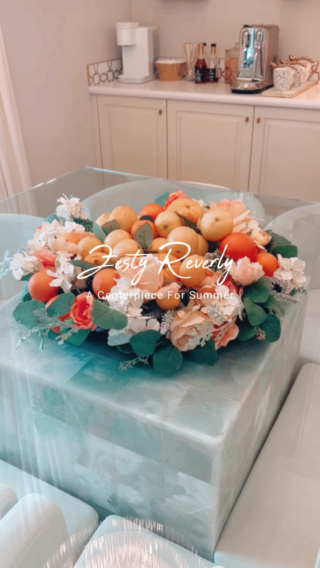 Now, it's been quite some time, hasn't it, since I’ve shared with you a wreath centerpiece? And, this one, is the epitome of a summer romance. With an undeniable beauty, it's abundant, rife with a fetching array of fruits and flowers taking turns to catch the eye. The natural splendor barely needs any adornment (though, of course, a little stardust never hurts, does it?). 
I've teased the flowers within the wreath, then placed a footed bowl right in the heart of it, filled to the brim with clear packaging material for that captivating 'dome' illusion. Next came a celebration of citrus, lemons and oranges taking turns, until it was bursting at the seams. 
And just like that, it's complete! A glorious summer centerpiece that's equal parts luscious, luxurious and undeniably elegant. I linked for you all the products I used on my LTK page! {P.S. This wreath is on sale!} 💐 


#LTKSeasonal