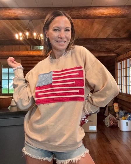 Fourth of July is just around the corner! I found this darling American flag sweater at free people! Perfect for cooler summer nights or watching fireworks! Wearing size small in sweatshirt and size small in jean shorts. 

#LTKOver40 #LTKStyleTip #LTKSeasonal